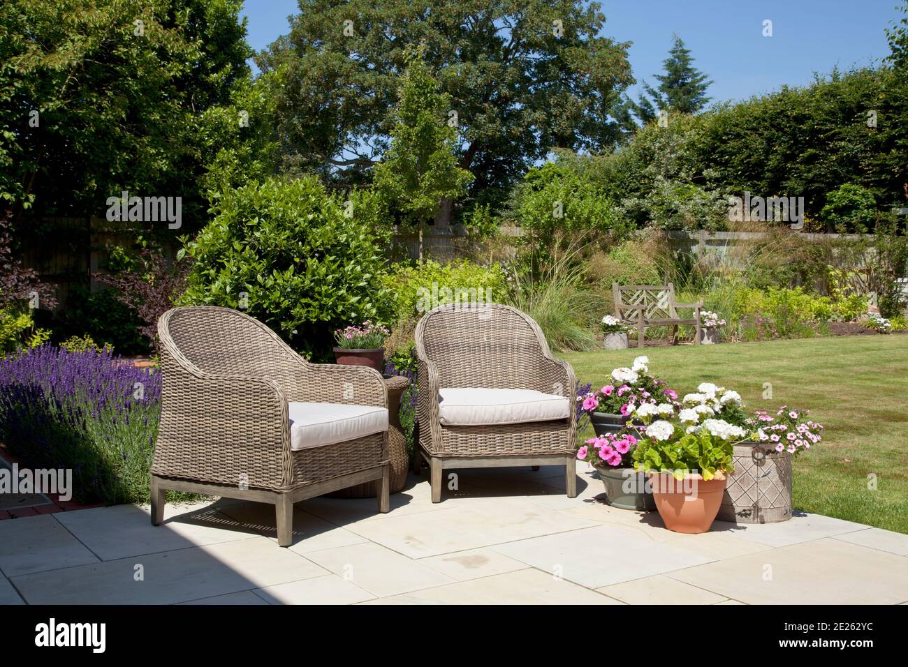 Pair of rattan chairs on garden terrace Stock Photo - Alamy