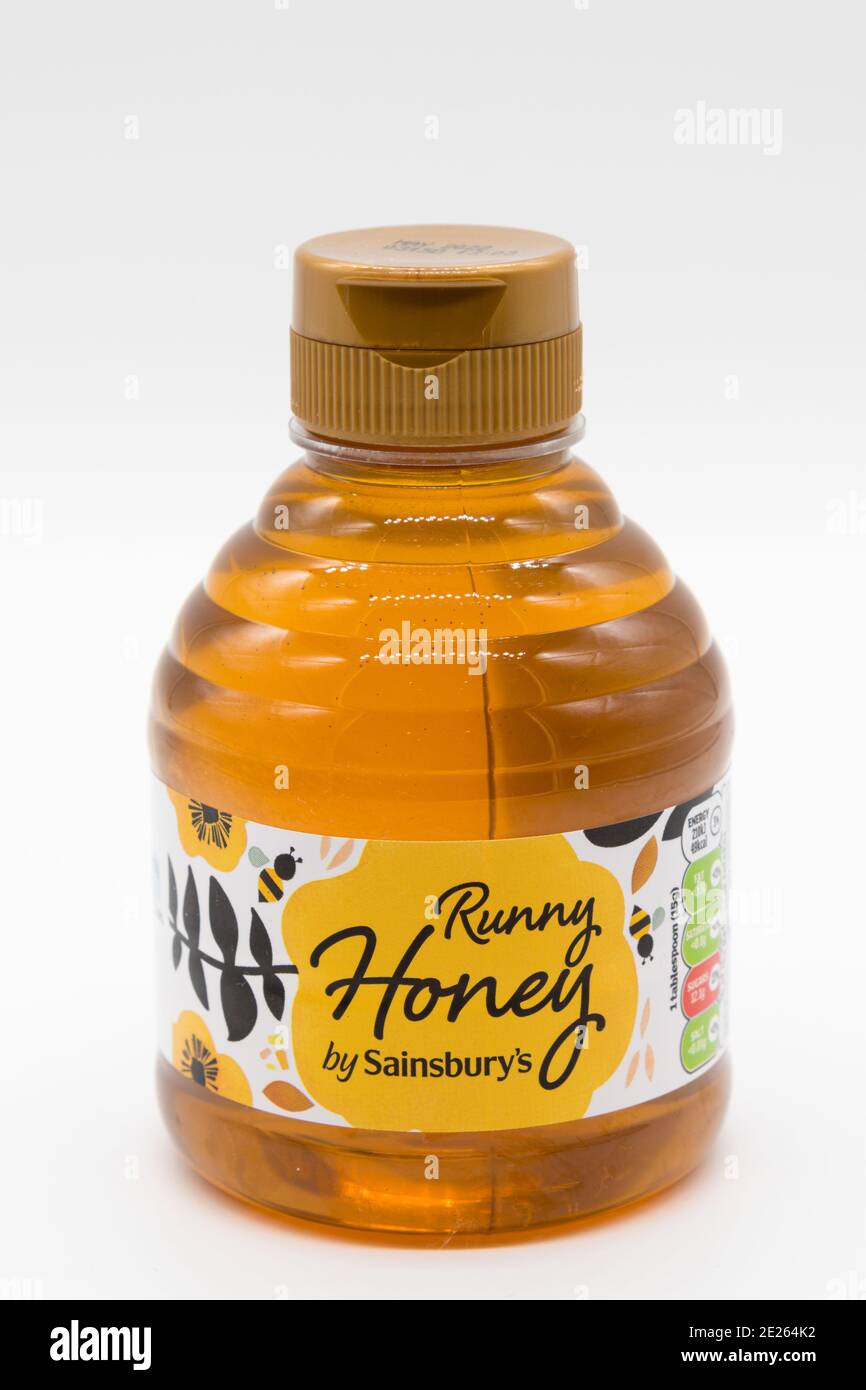 Irvine, Scotland, UK - January 09, 2021: Sainsbury's Branded bottle of  Runny Honey in a bottle and cap that is recyclable. Paper labels displaying  sym Stock Photo - Alamy