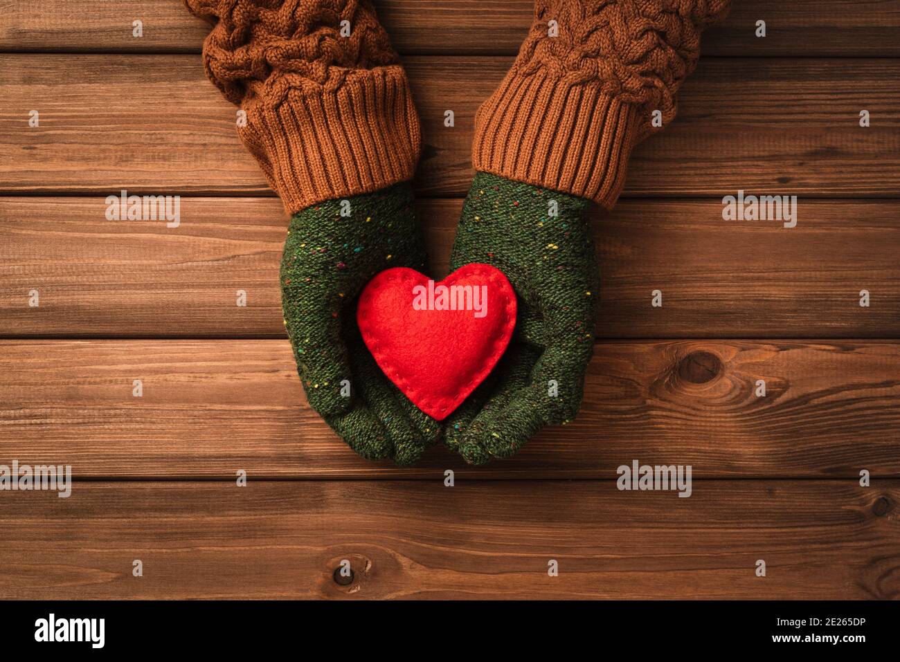 Valentines day card with red heart on woman palms on vintage wooden ...