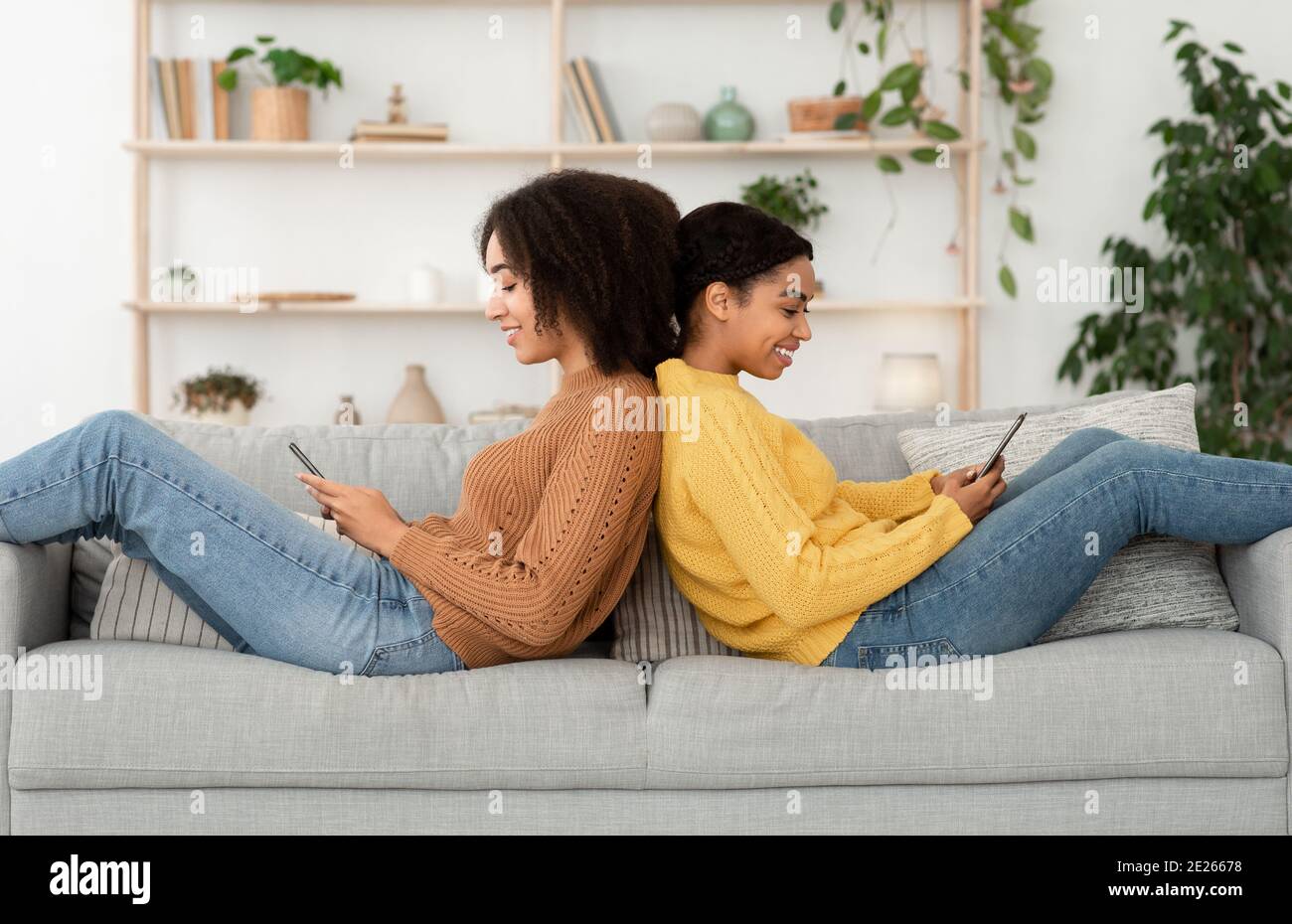 Mixed race couple browsing gadgets hi-res stock photography and images ...