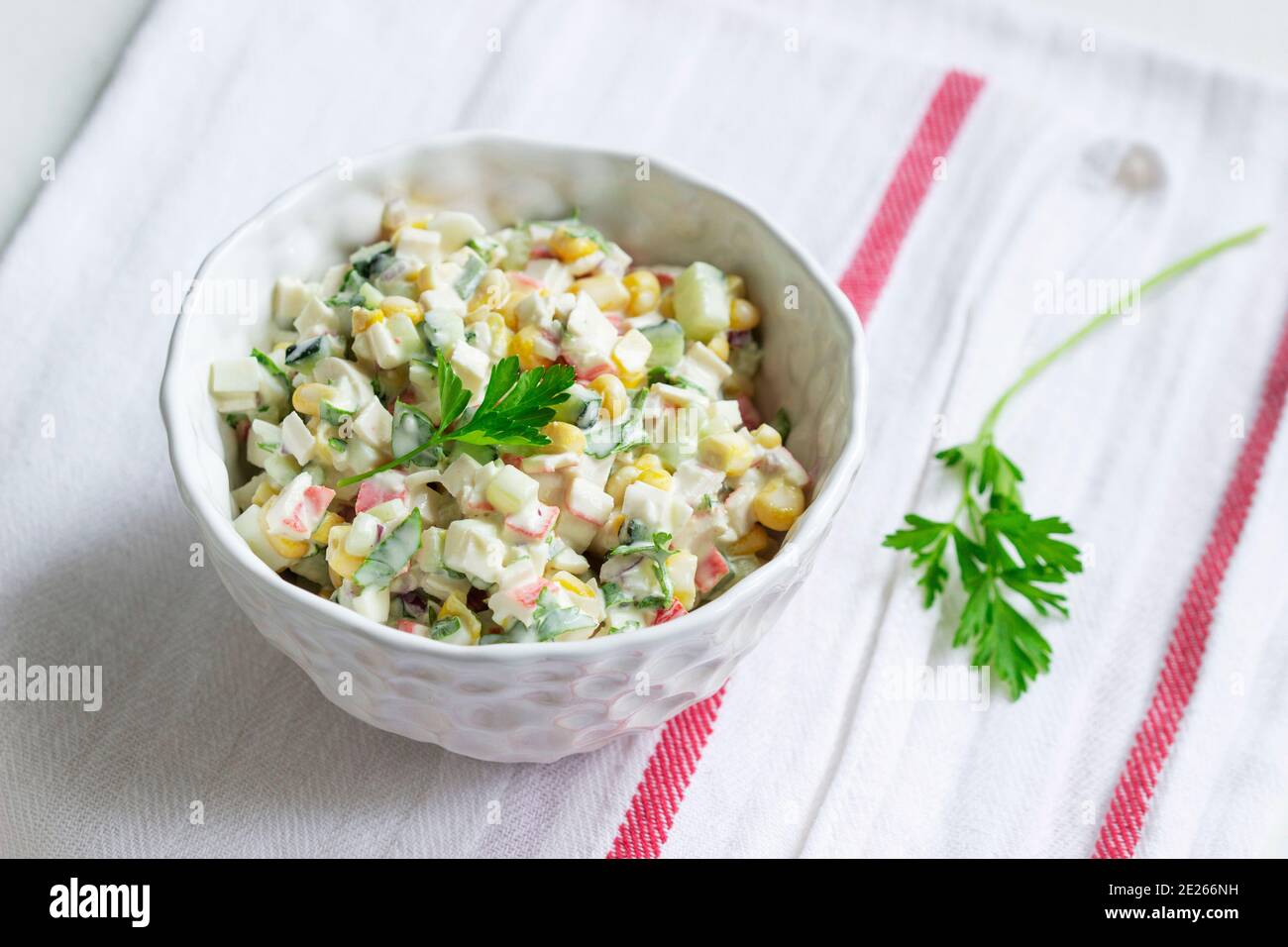 Vegetable salad with crab sticks, dressed with mayonnaise. Stock Photo