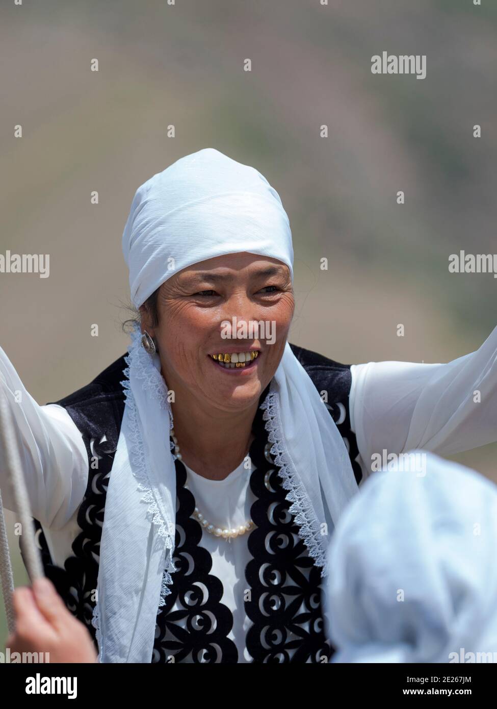 Woman in traditional garb having fun on a swing.  Folk Festival commemorating the origin myth the Tien Shan Maral (Tian Shan wapiti), an origin myth o Stock Photo