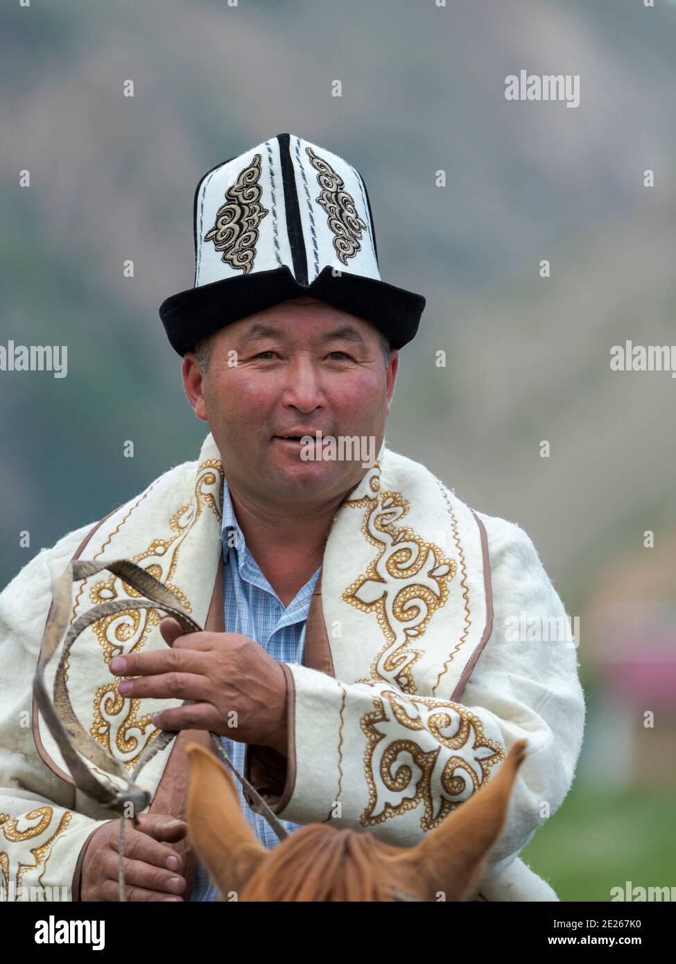 Participant in traditional garb. Folk Festival commemorating the origin myth the Tien Shan Maral (Tian Shan wapiti), an origin myth of the Kyrgyz trib Stock Photo