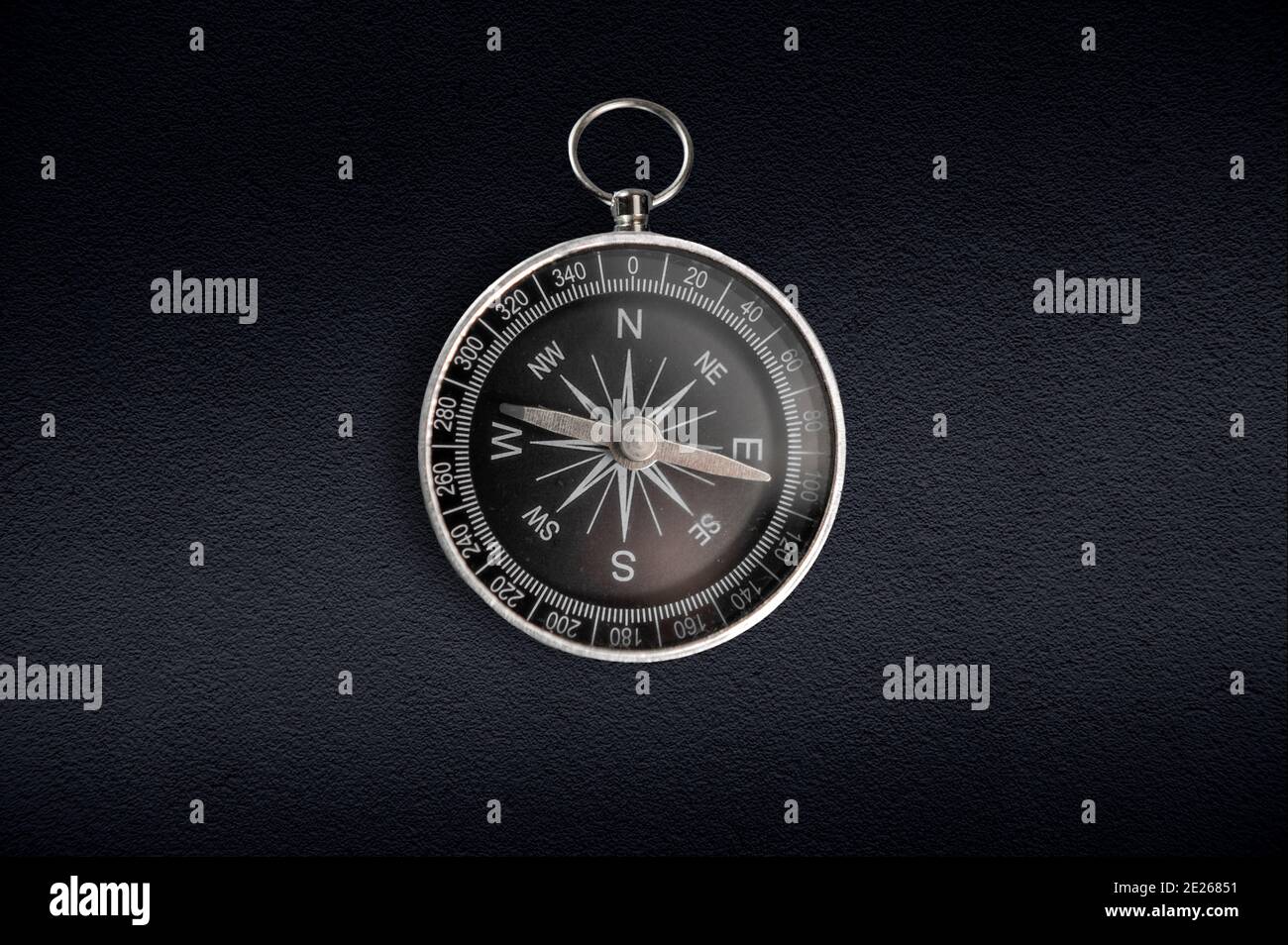 Compass isolated on dark background. Close-up. Stock Photo