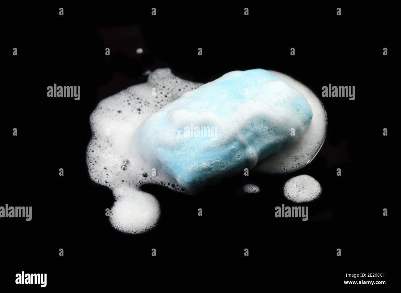 Soap bar with foam isolated on white background. Wet bar of soap Stock