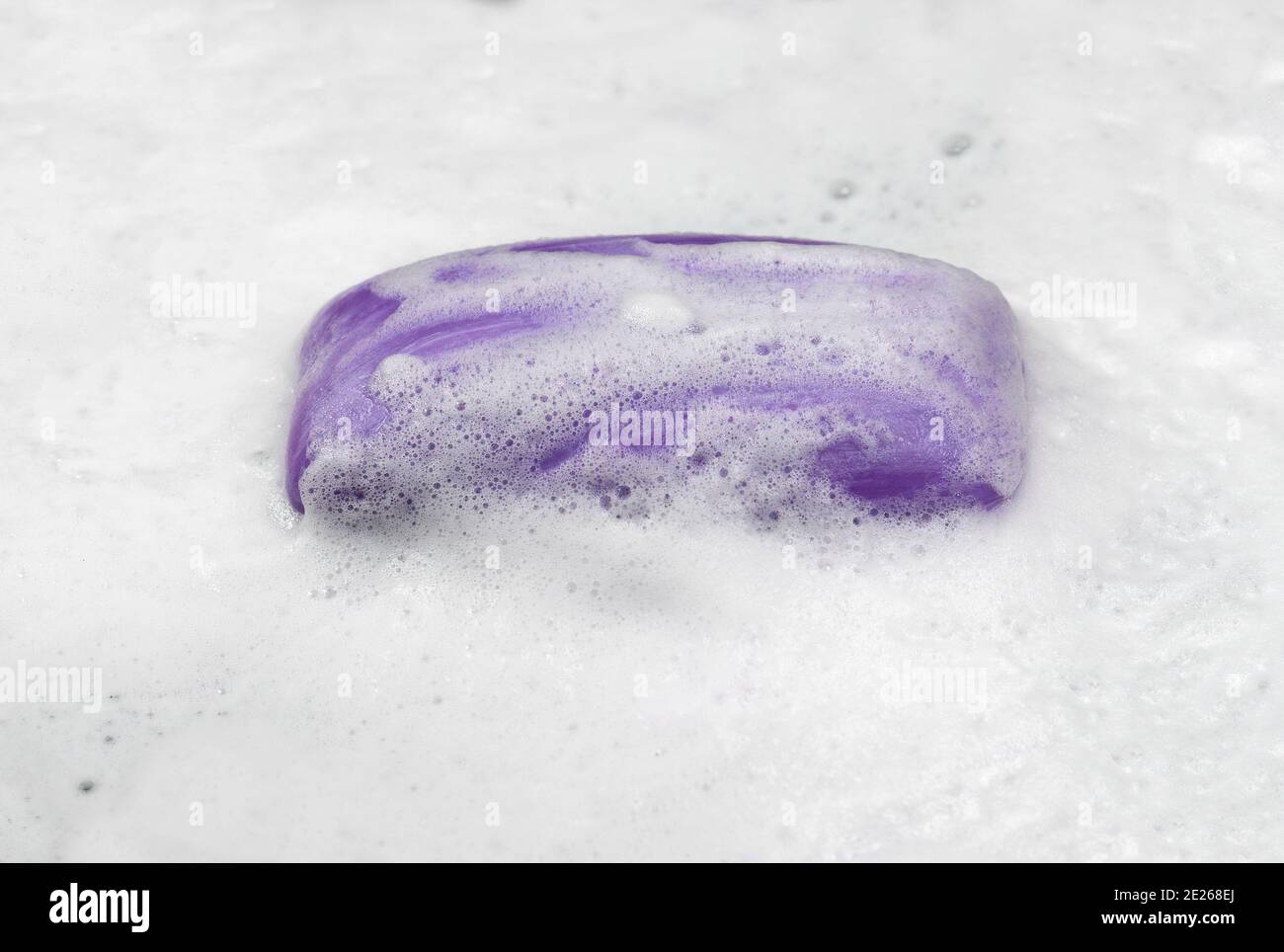 Soap bar with foam isolated on white background. Wet bar of soap Stock