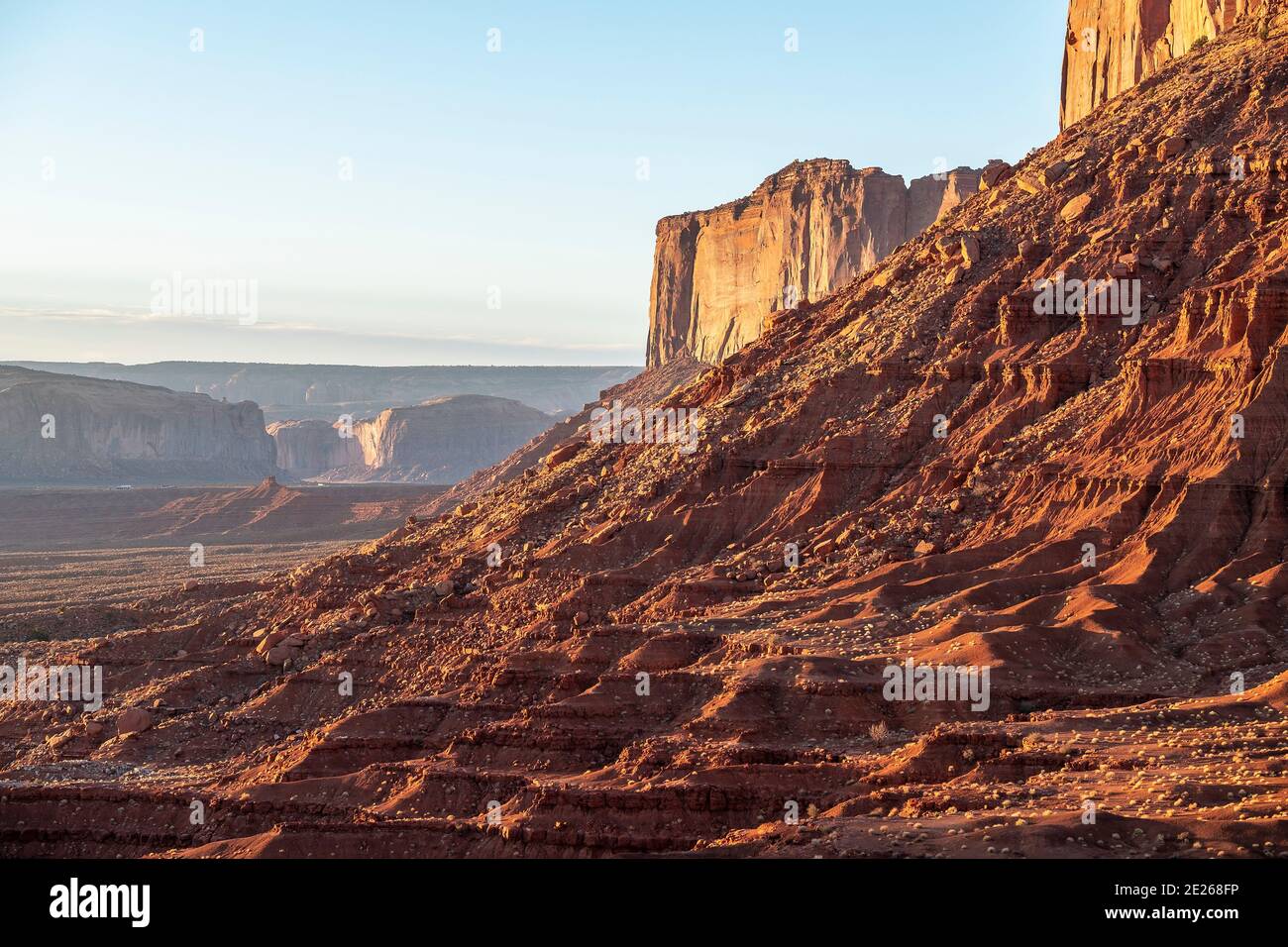 Sunrise light on the Mitchell Mesa rock formation in Monument Valley Navajo Tribal Park which straddles the Arizona and Utah state line, USA Stock Photo