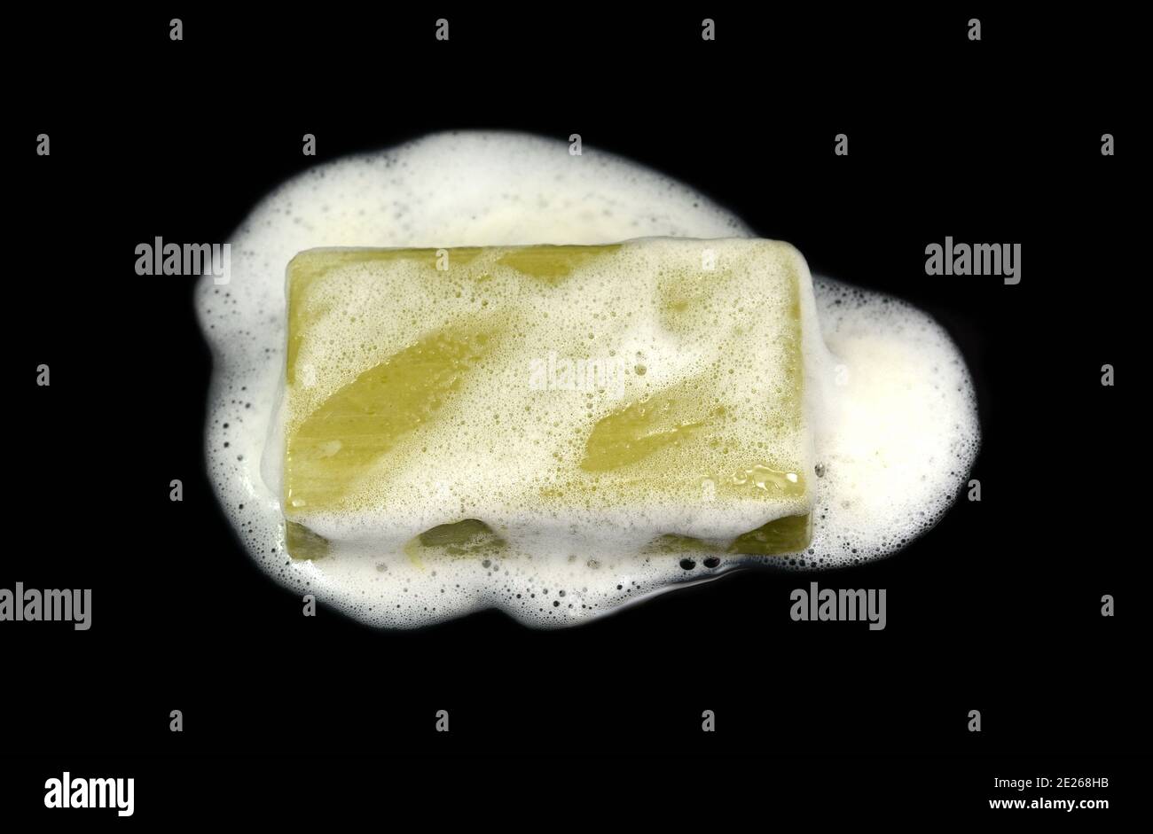 Soap bar with foam isolated on white background. Wet bar of soap Stock