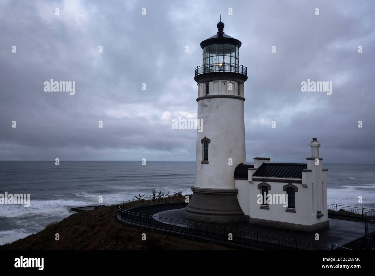 WA19106-00...WASHINGTON - Cloudy morning sunrise at North Cape Lighthouse in Cape Disappointment State Park. Stock Photo