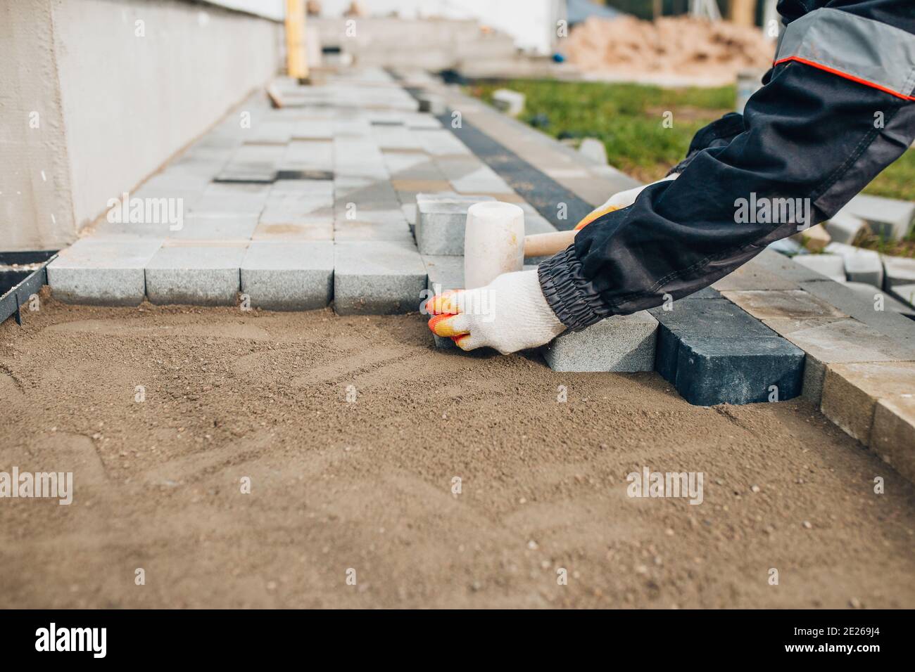 Construction of a path on the site around the house - concrete paving stones Stock Photo
