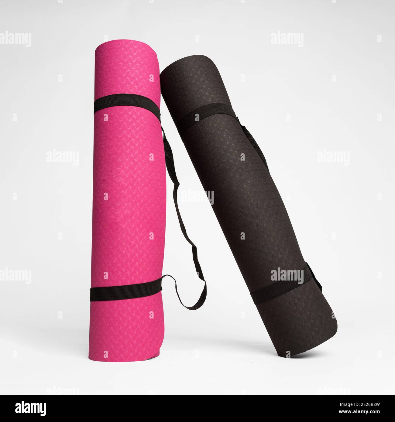 Closeup shot of two rolled up fitness mat isolated on a white ...