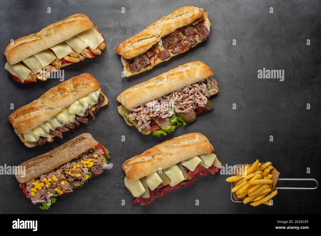 Set of various assorted roasted panini sandwiches over stone background ...