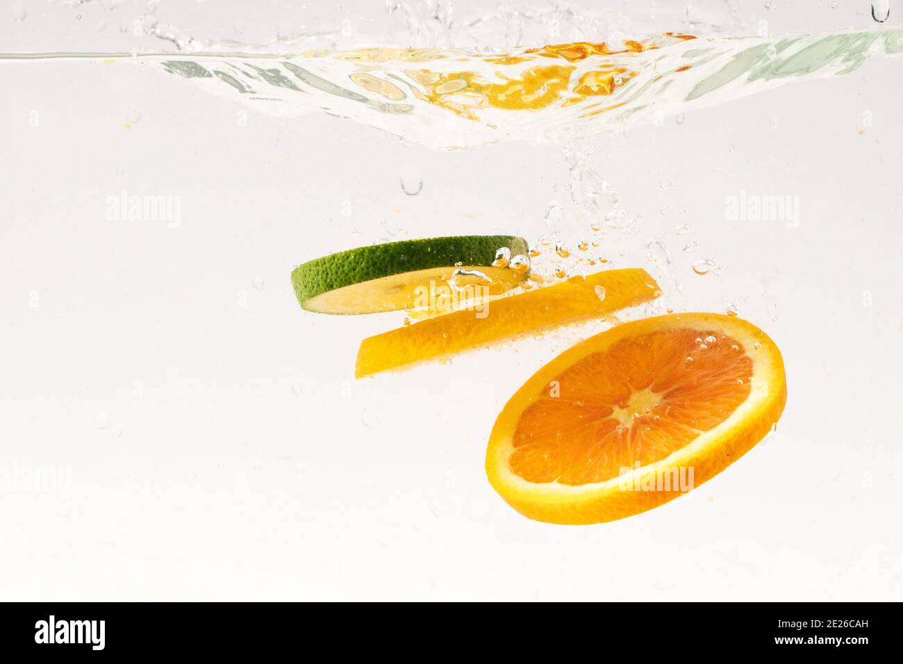 Slices floating in water on white background Stock Photo