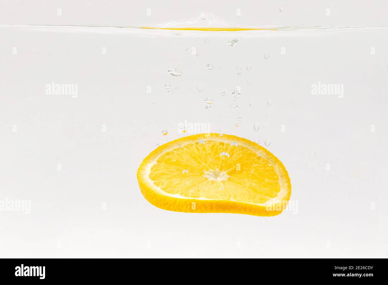 Slice floating in water on white background Stock Photo - Alamy