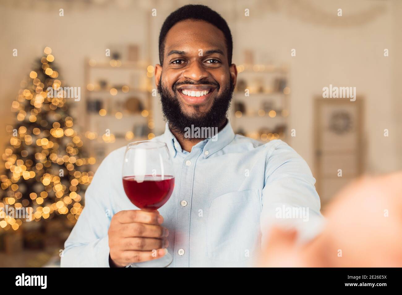 Black man drinking red wine, looking at camera Stock Photo Alamy
