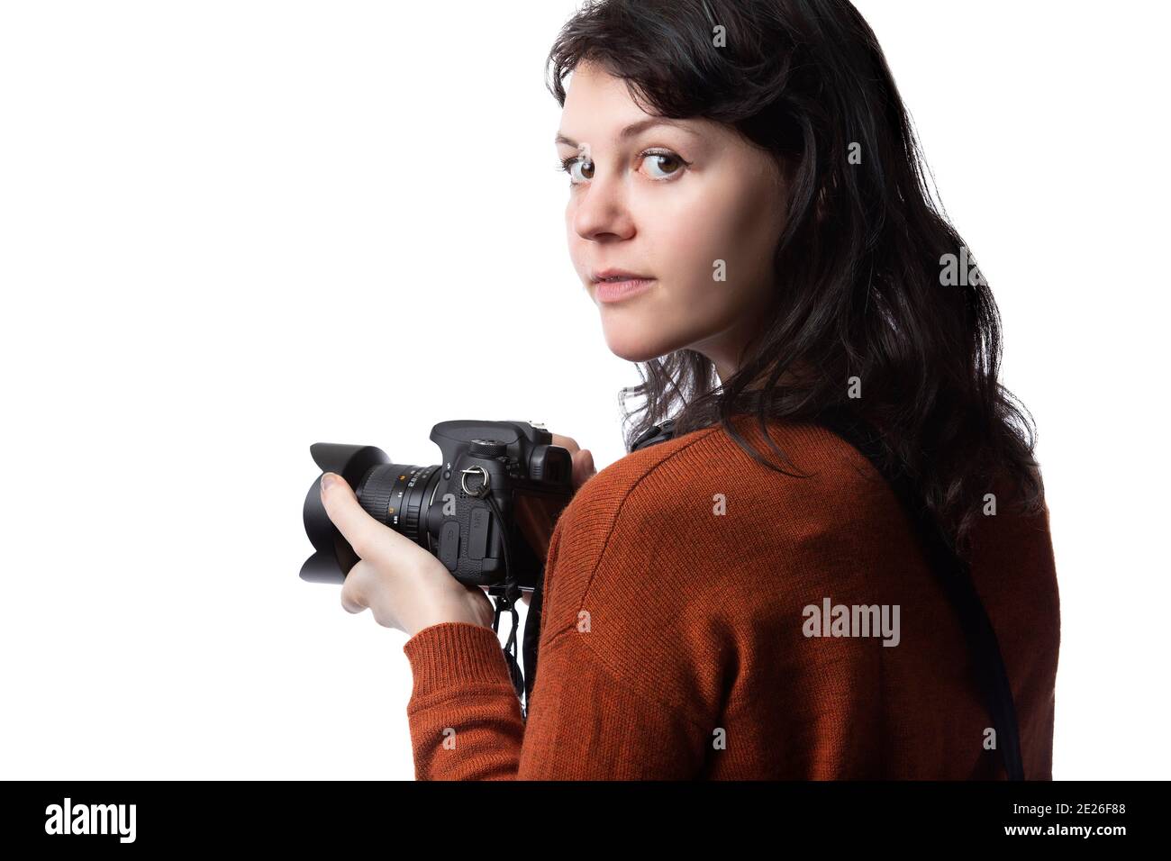 Side view of a female photographer holding a camera isolated on a white
