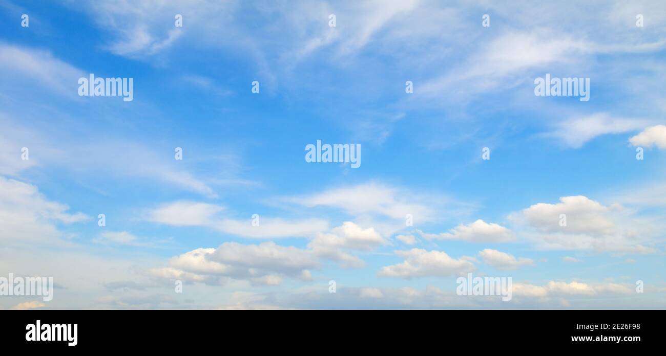 Light cumulus clouds in the blue sky. Wide photo Stock Photo - Alamy