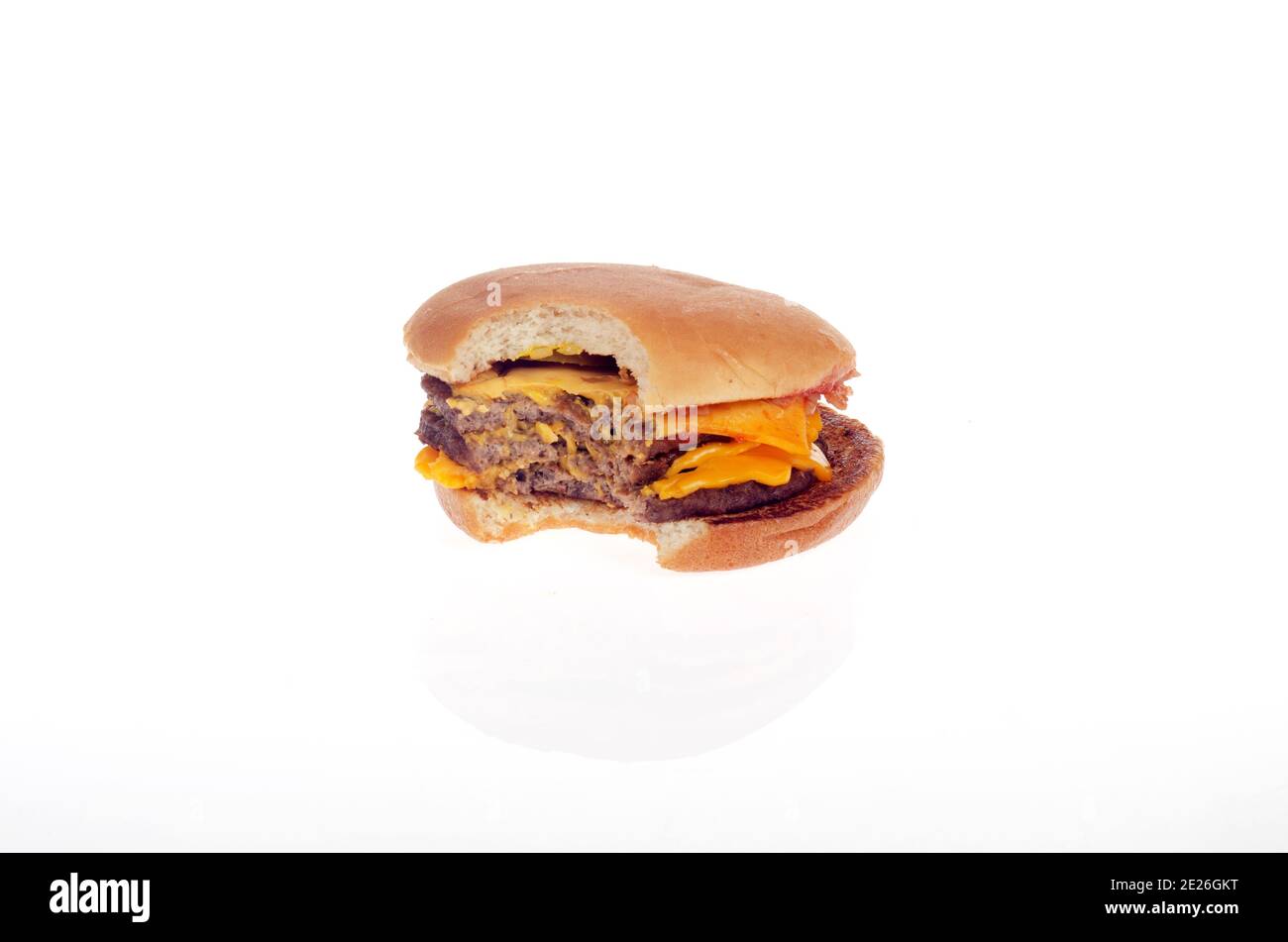 McDonalds Triple Cheeseburger with bite taken out on white background Stock Photo