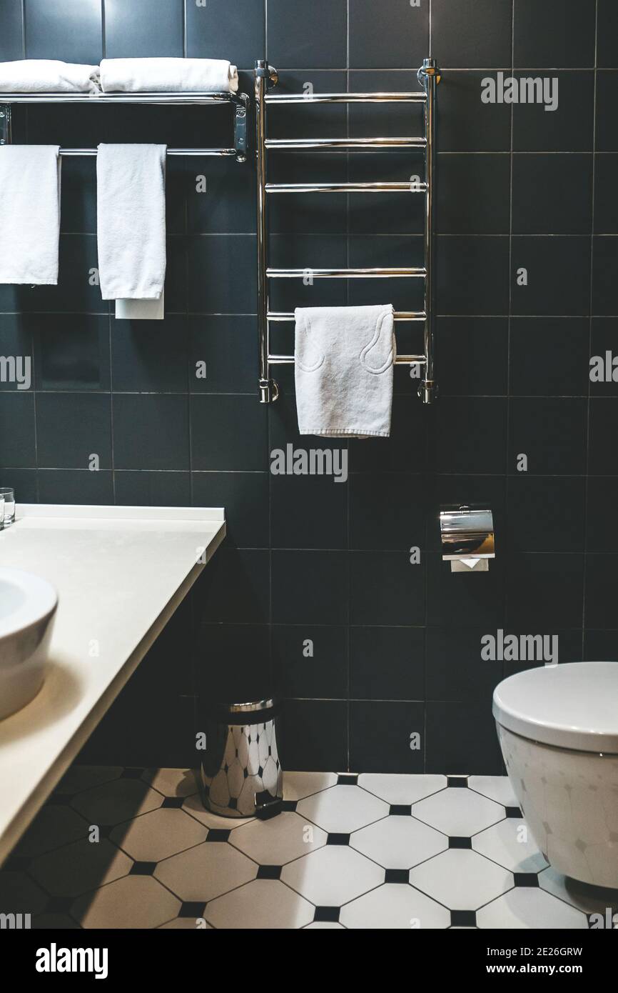 Towels are hanging on the heated towel rail in the bathroom Stock Photo