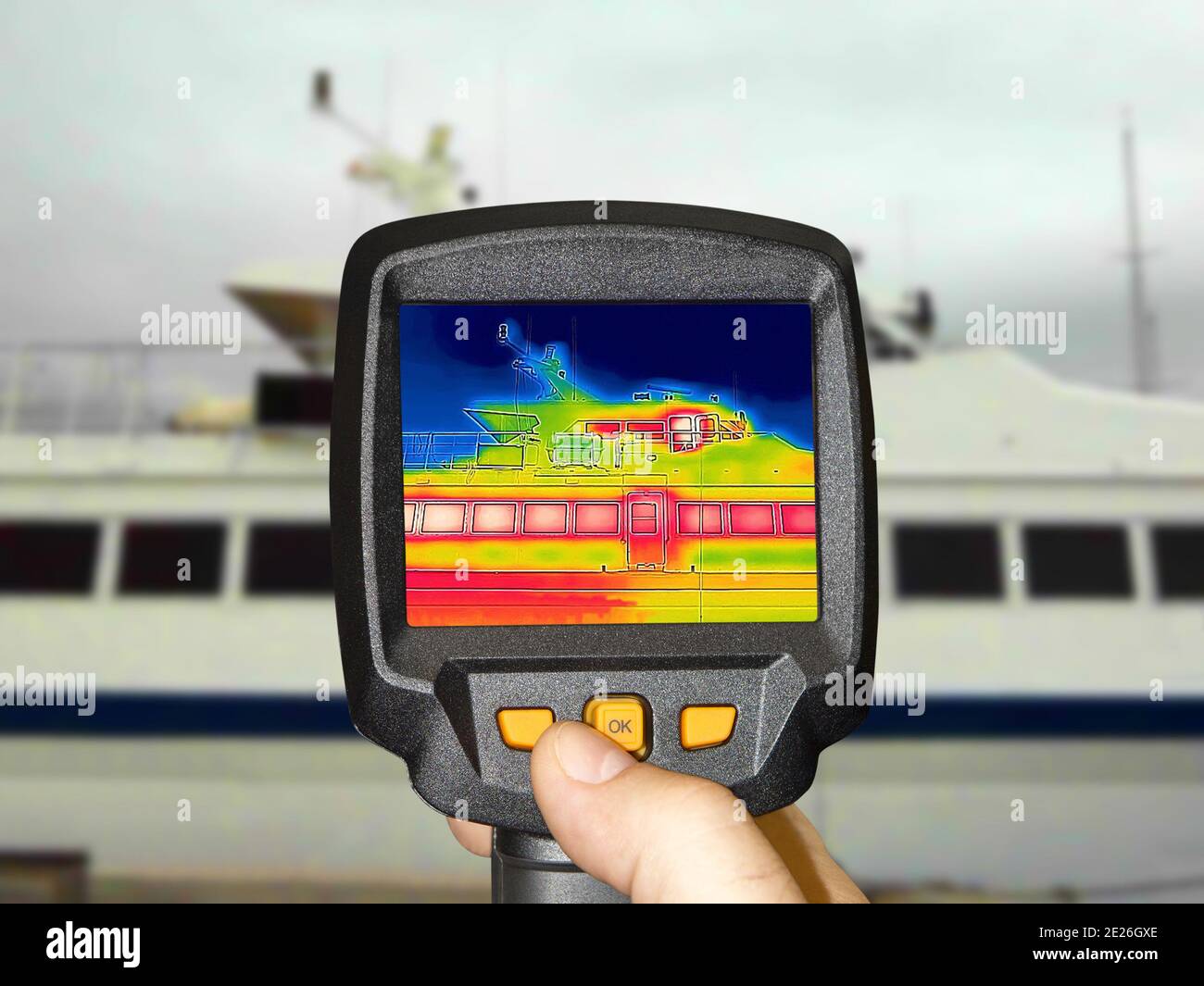 Recording Heat Loss Outside anchored luxury private motor yacht Using Infrared Thermal Camera Stock Photo