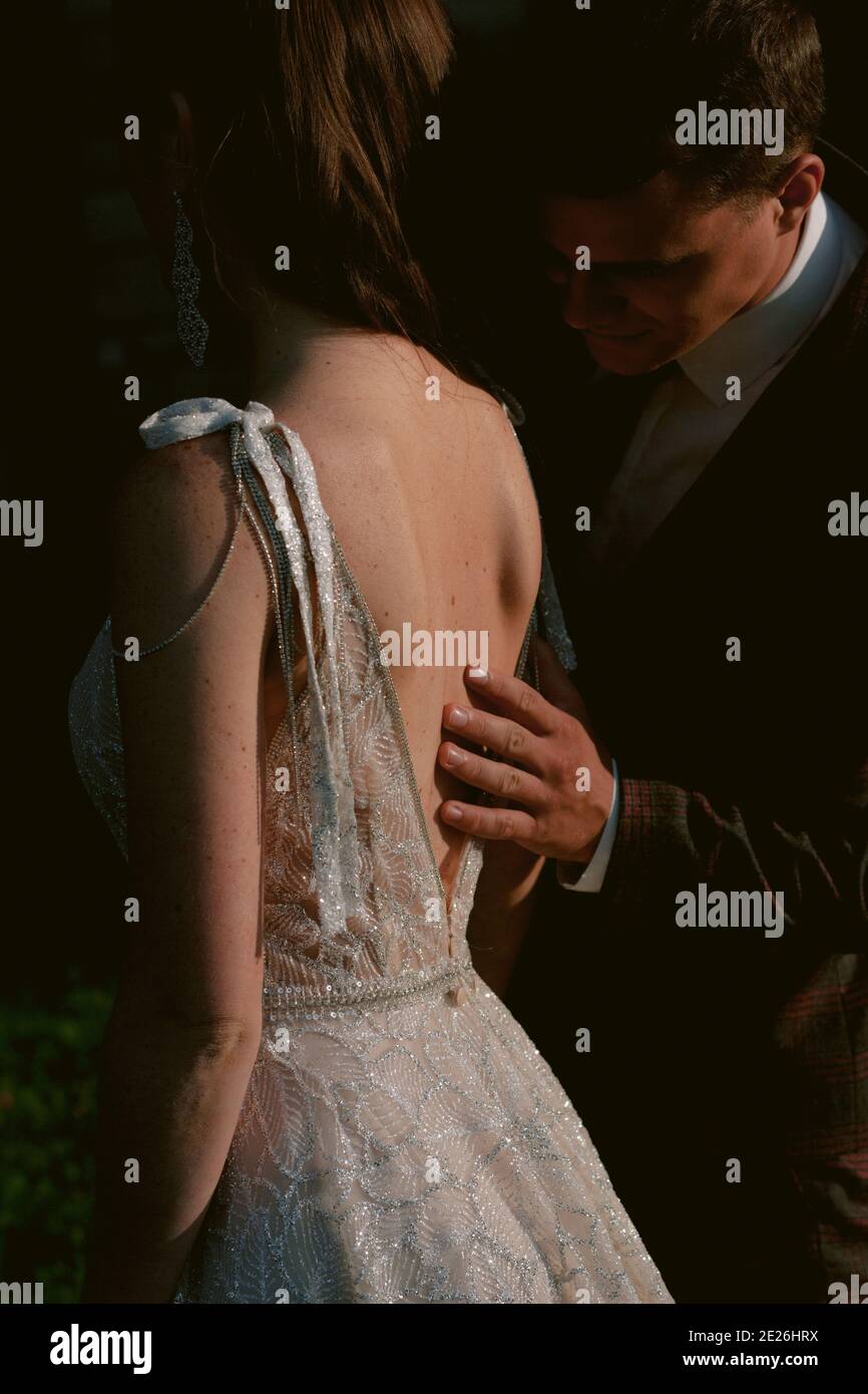 The groom touching the back of the bride. Closeup bride and groom portrait. Place for your text. Wedding couple. Wedding photo Stock Photo