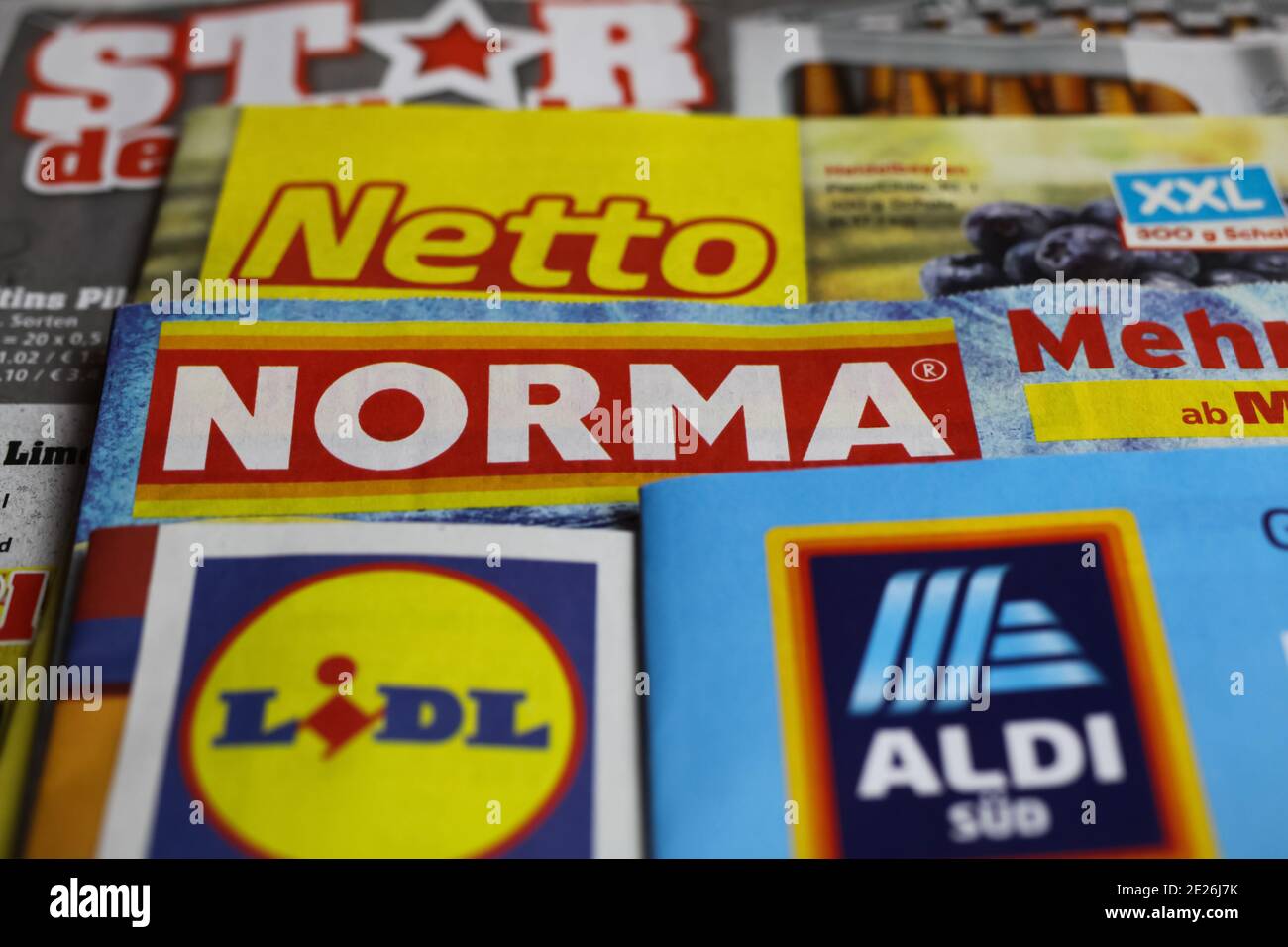 Viersen, Germany - January 9. 2021: Macro closeup of weekly printed advertising inserts from german discounter companies lidl, aldi, norma, netto (foc Stock Photo