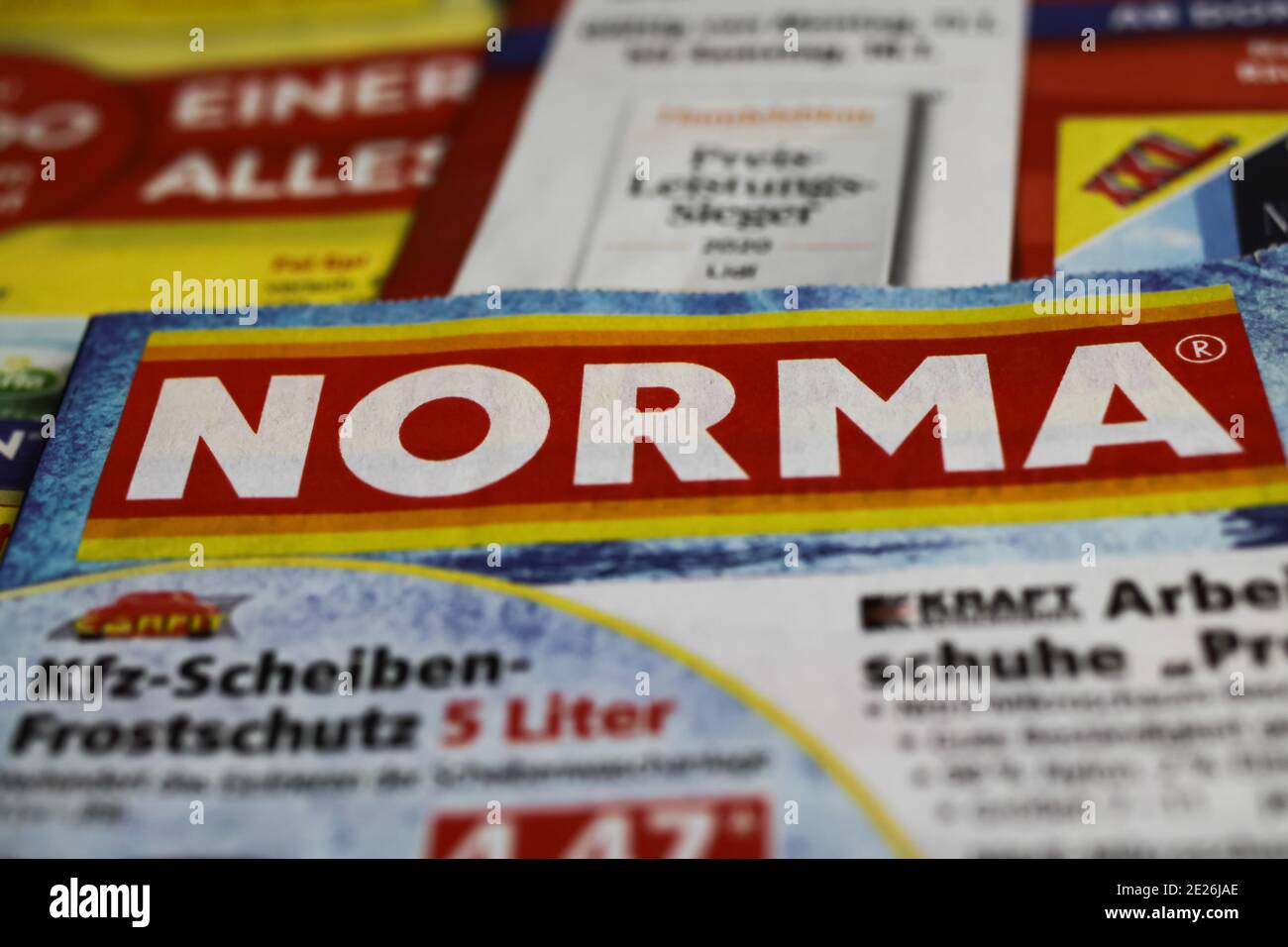 Viersen, Germany - January 9. 2021: Macro closeup of weekly printed advertising inserts from german discounter company Norma (focus on center) Stock Photo