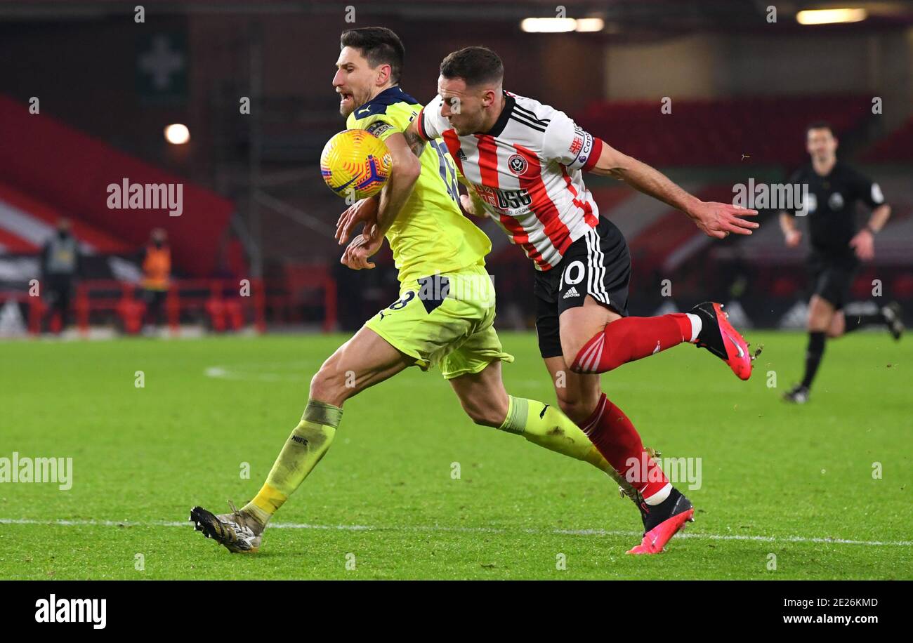 Newcastle United's Federico Fernandez (left) and Sheffield United's Billy Sharp battle for the ball during the Premier League match at Bramall Lane, Sheffield. Stock Photo