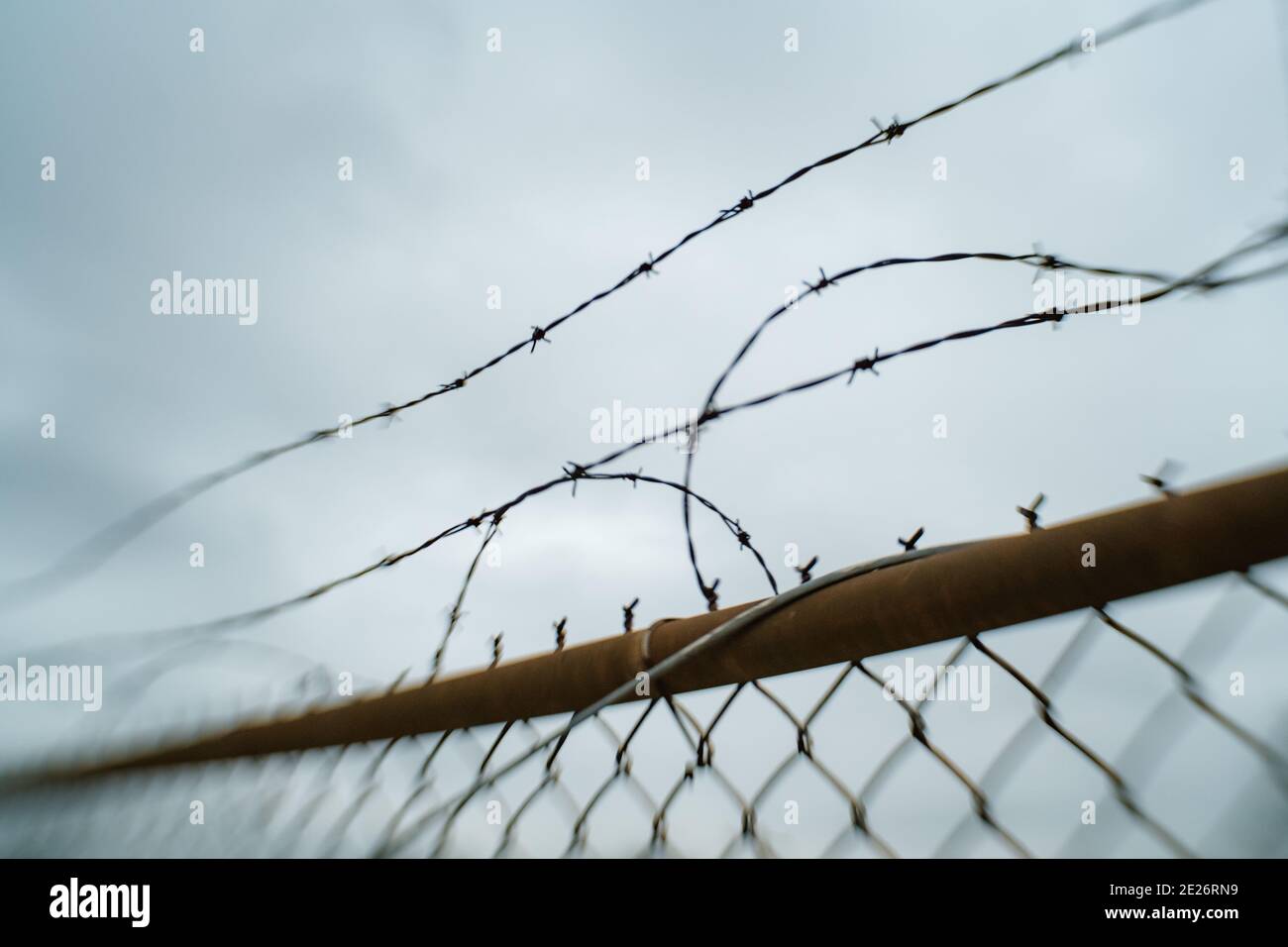 Chain link barbed wire fence close up Stock Photo