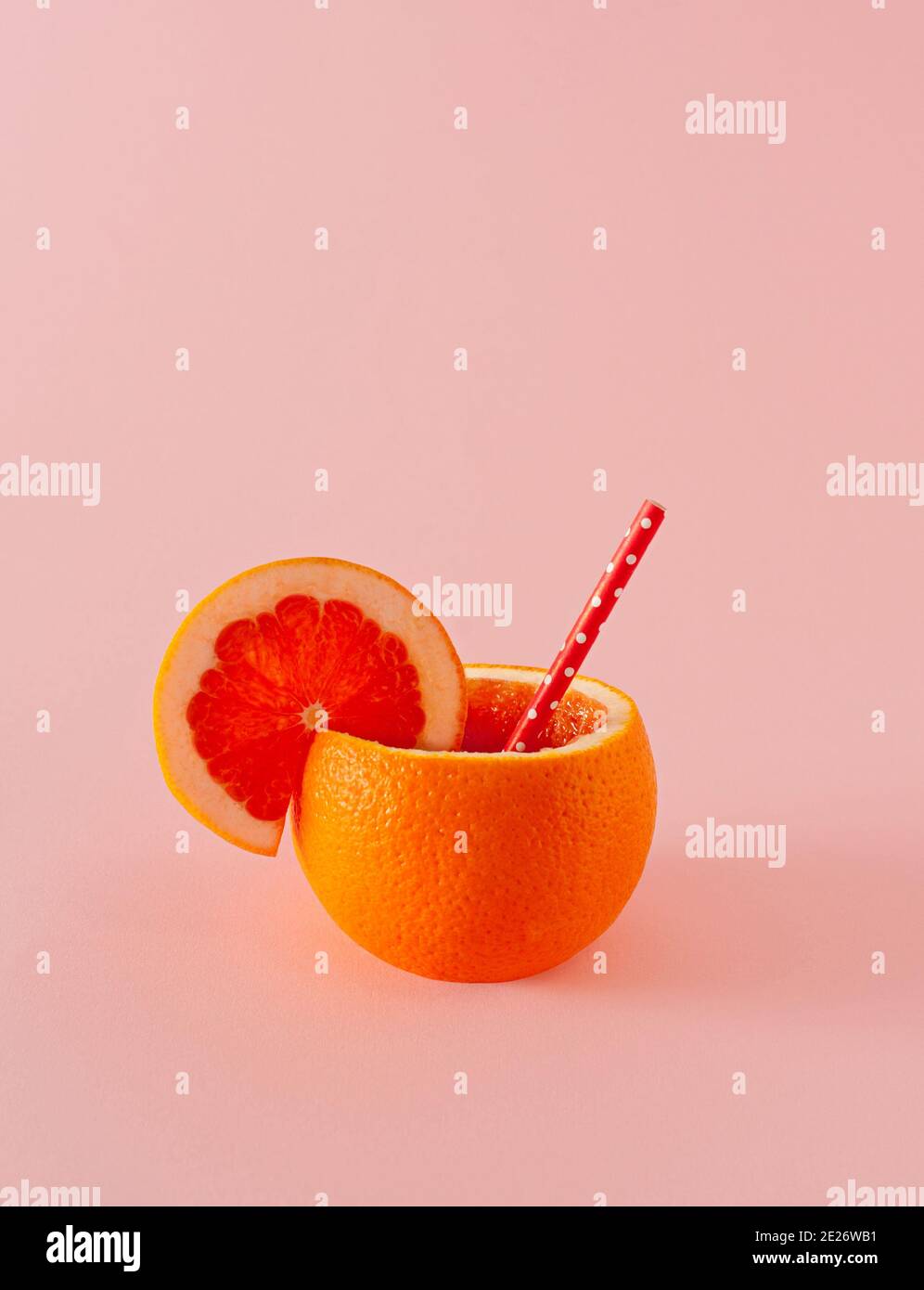 Fresh orange in the form of a container for juice.  The concept of freshly squeezed citrus juices. Serving of raw, fresh orange cocktail. Stock Photo