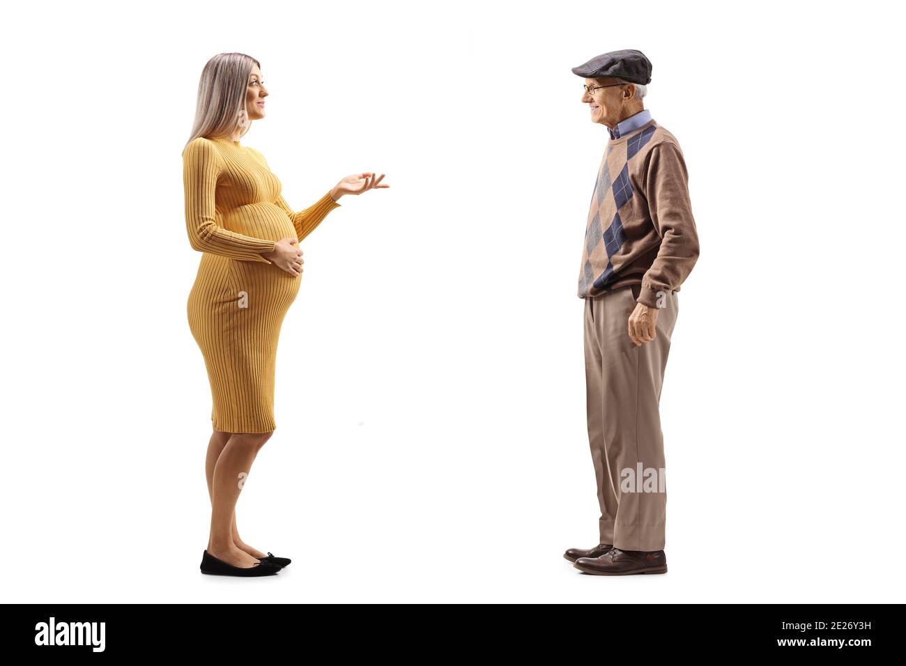 Full length profile shot of a pregnant woman talking to an elderly gentleman isolated on white background Stock Photo
