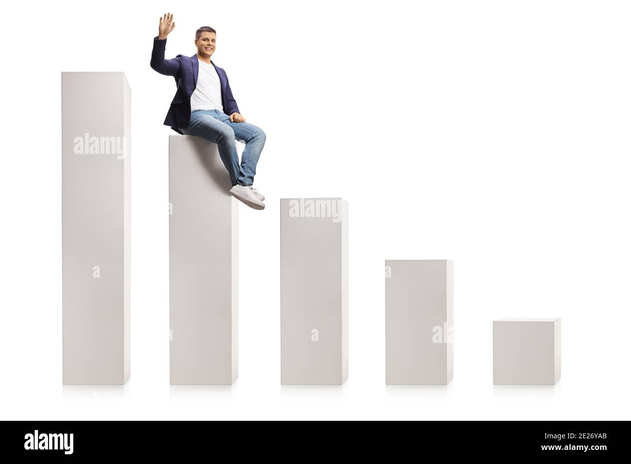 Man in jeans and suit sitting on a bar graph and waving at camera isolated on white background Stock Photo