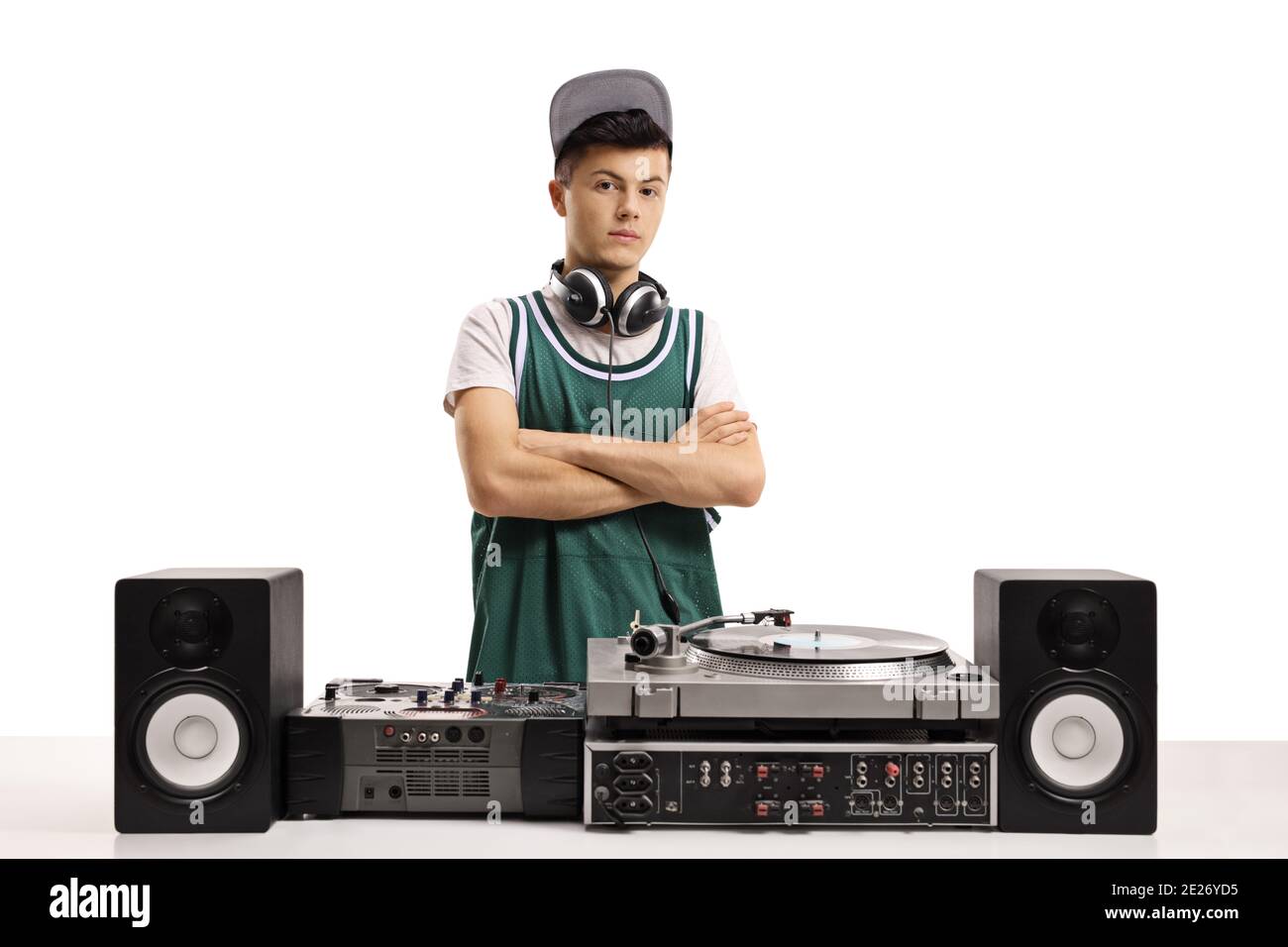 Young male dj with vinyl turntable posing with crossed arms isolated on white background Stock Photo