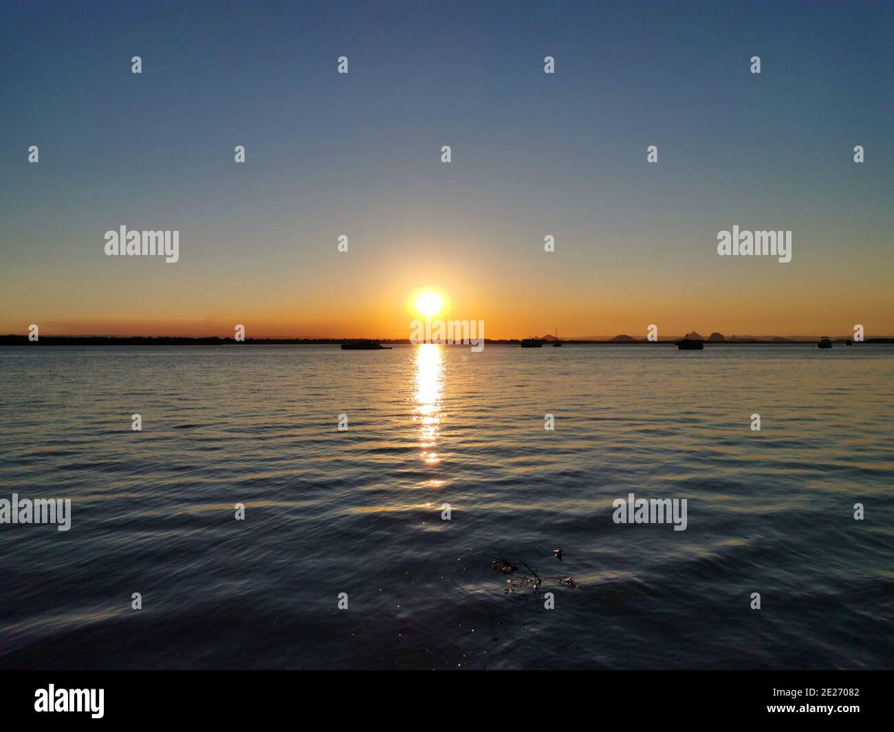 Stunning seascape at sundown reflecting on the water surface Stock Photo