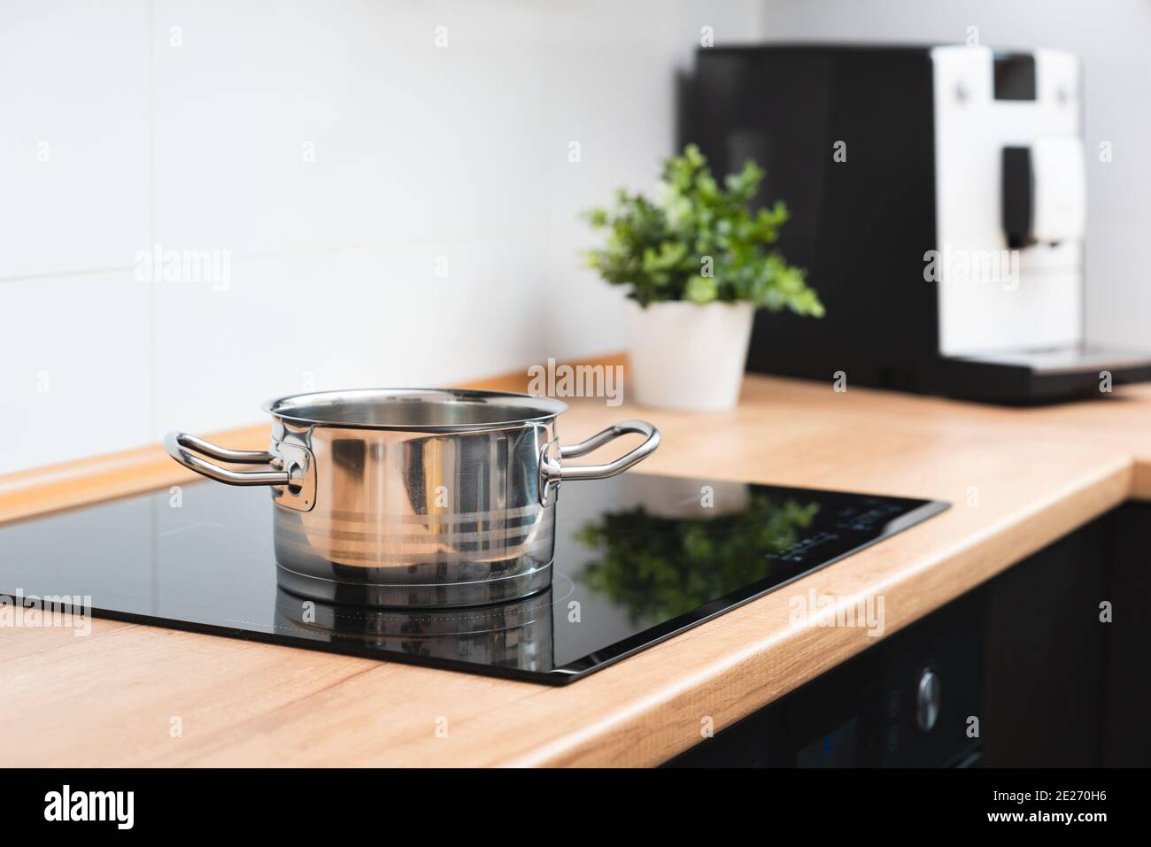Pot in the kitchen on the induction hob. Induction electrical stove