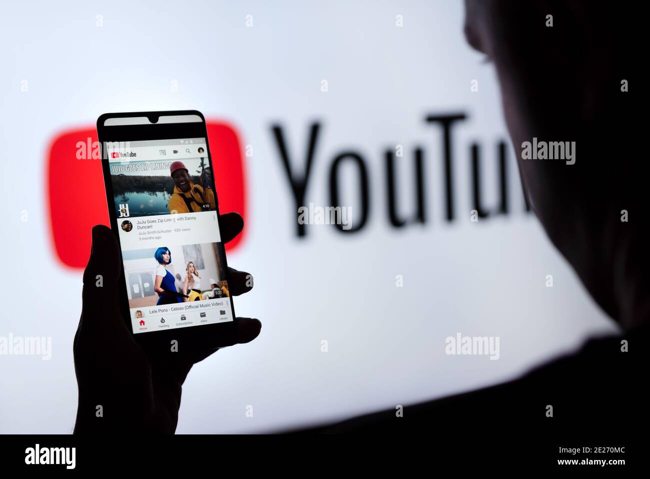 Wroclaw, Poland - SEP 16, 2020: Man holding smart phone with YouTube logo on screen. YouTube is most popular video service developed by Google. Stock Photo