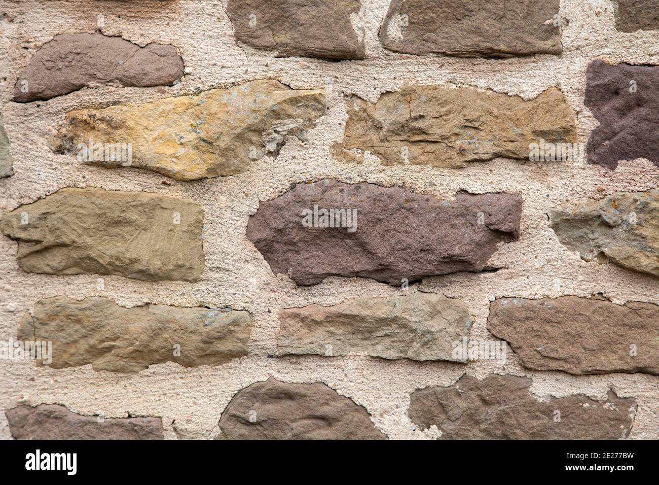 Pattern background of an old rough stone wall with cement Stock Photo ...