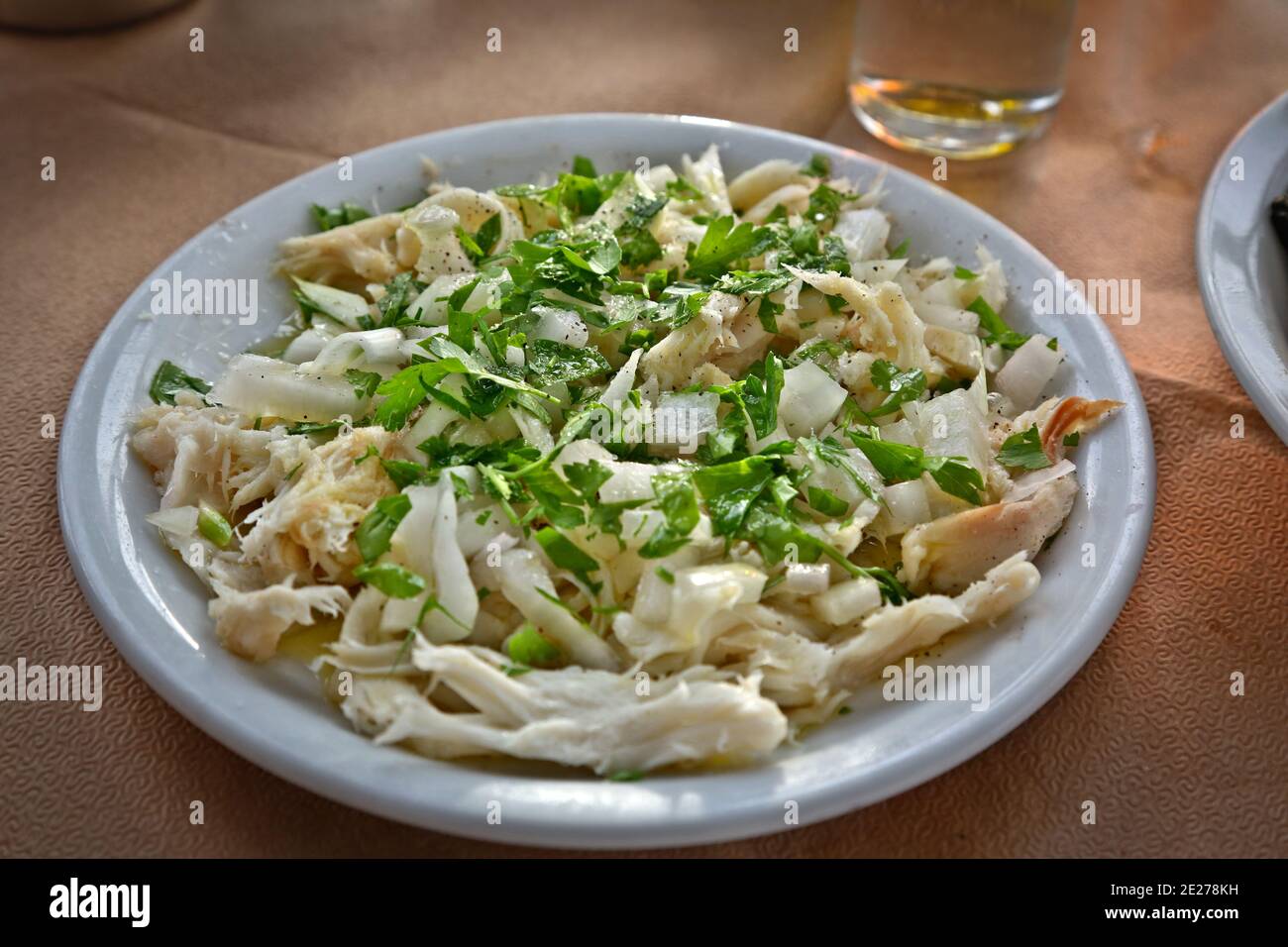 Saladuri is a delicacy common in the Cyclades islands. It is made from skate meat and vegetables and is often served as salad. Stock Photo