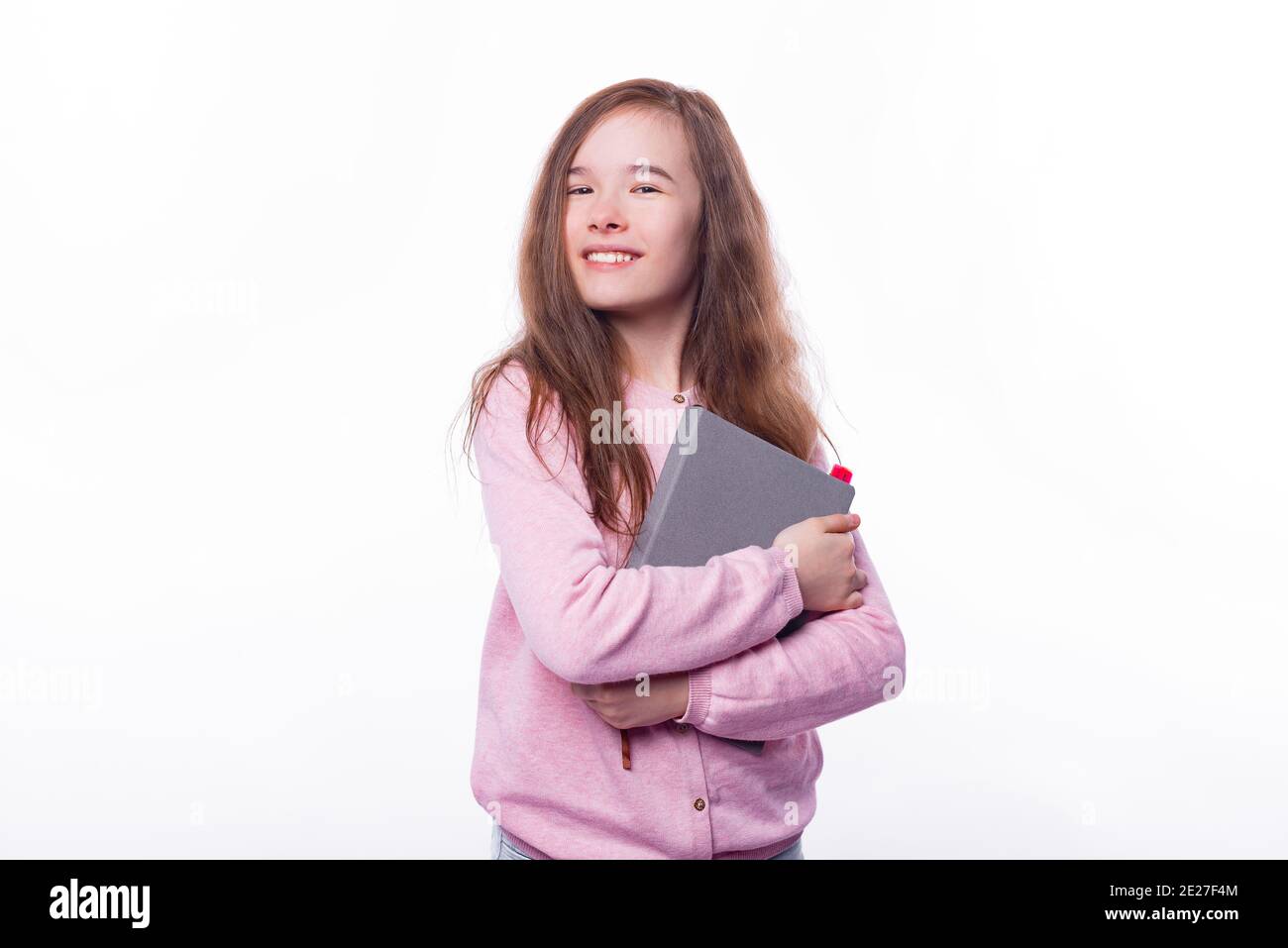 Portrait of joyful young girl holding planner over white background. Stock Photo