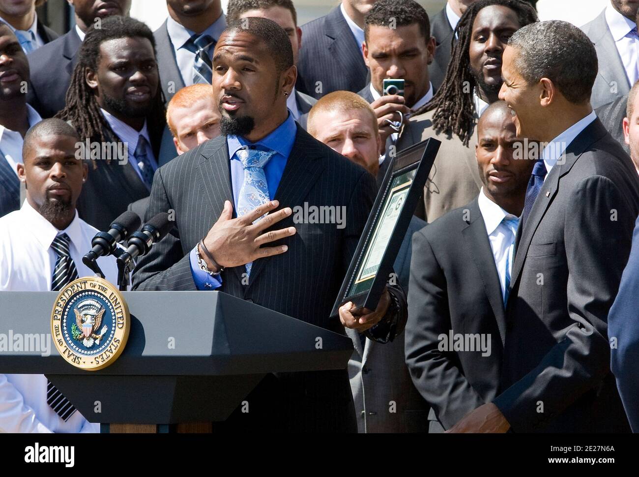 Green Bay Packers Player Charles Woodson presents an ownership share to President Barack Obama during an event to honor the Super Bowl XLV champions at the White House in Washington on August 12, 2011. The Packers are the only publicly owned NFL team in the United States. Photo by Kristoffer Tripplaar/Pool/ABACAPRESS.COM Stock Photo