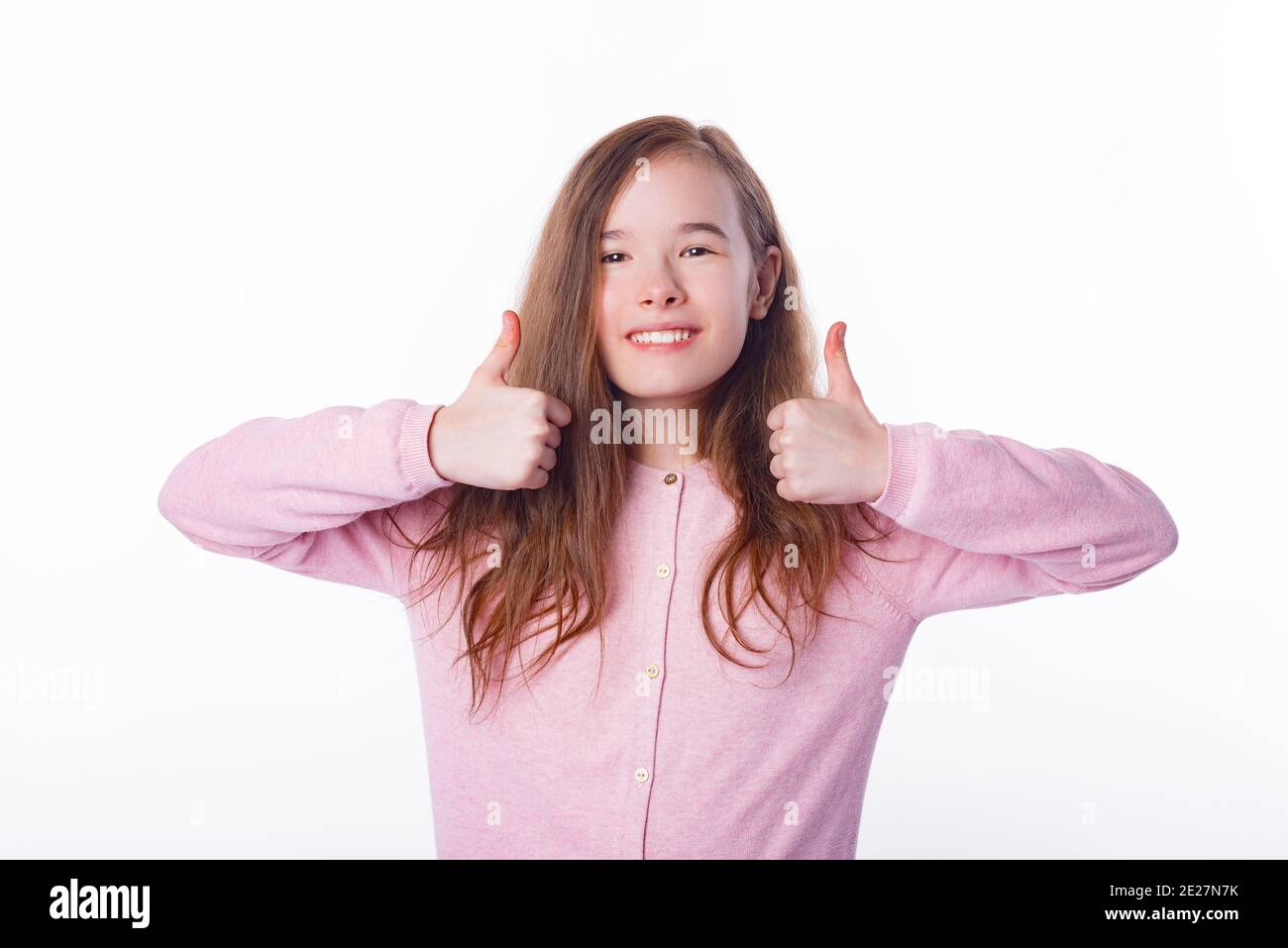 Photo of cute girl showing thumbs up over white background Stock Photo ...