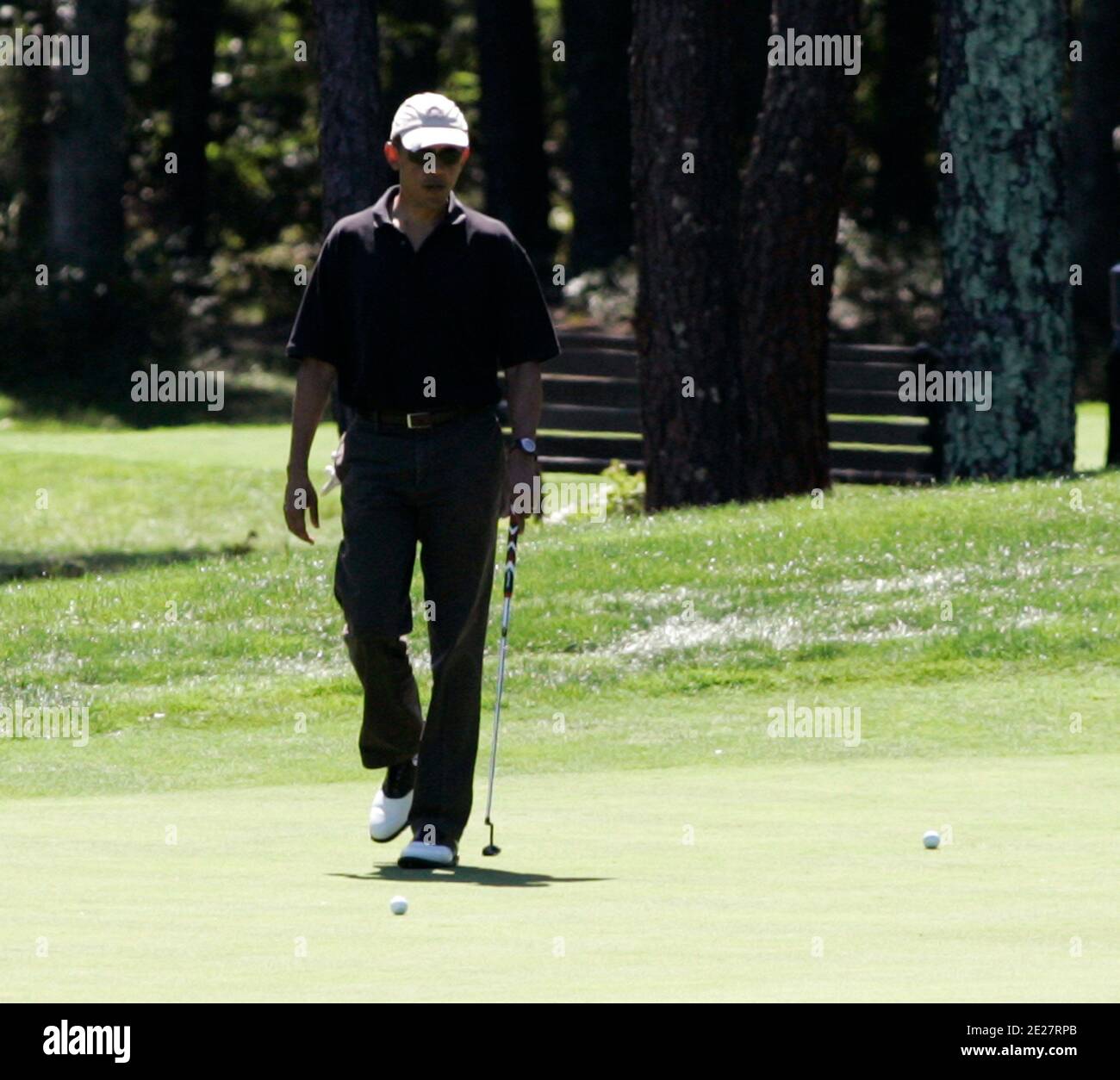 President Barack Obama plays the first hole of the Farm Neck Golf Club  while vacationing on
