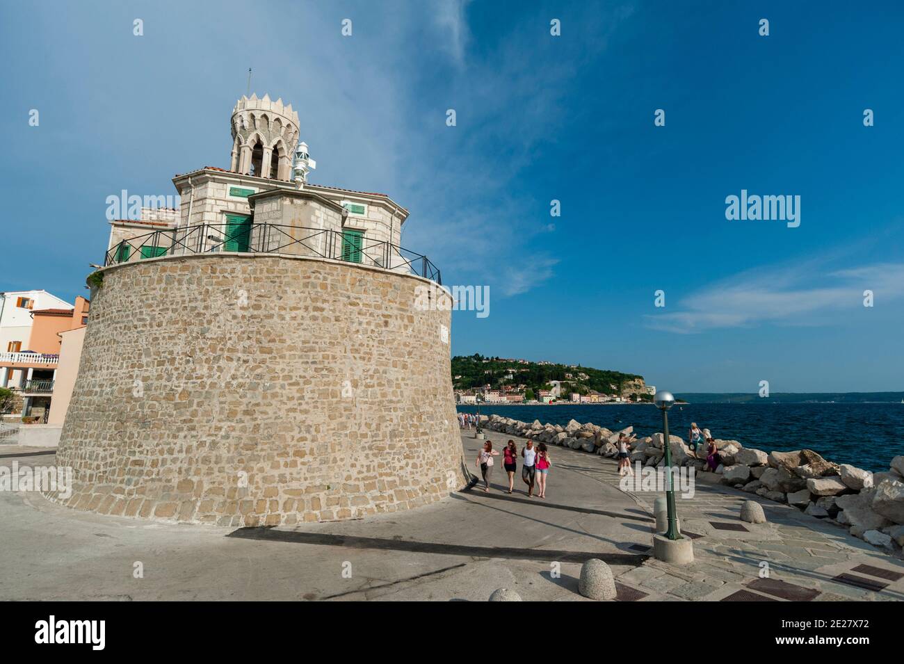 The lighthouse on Piran waterfront, Slovenia. Stock Photo