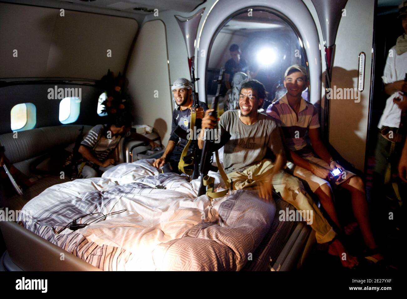 Libyan rebels get on board Afriqiyah airlines Airbus A-340 '5A-ONE' that belongs to their leader Muammar Gaddafi and discover the luxury of the revolutionary leader, at Tripoli International Airport, near Tripoli, Libya, on August 29, 2011. Photo by Ammar Abd Rabbo/ABACAPRESS.COM Stock Photo