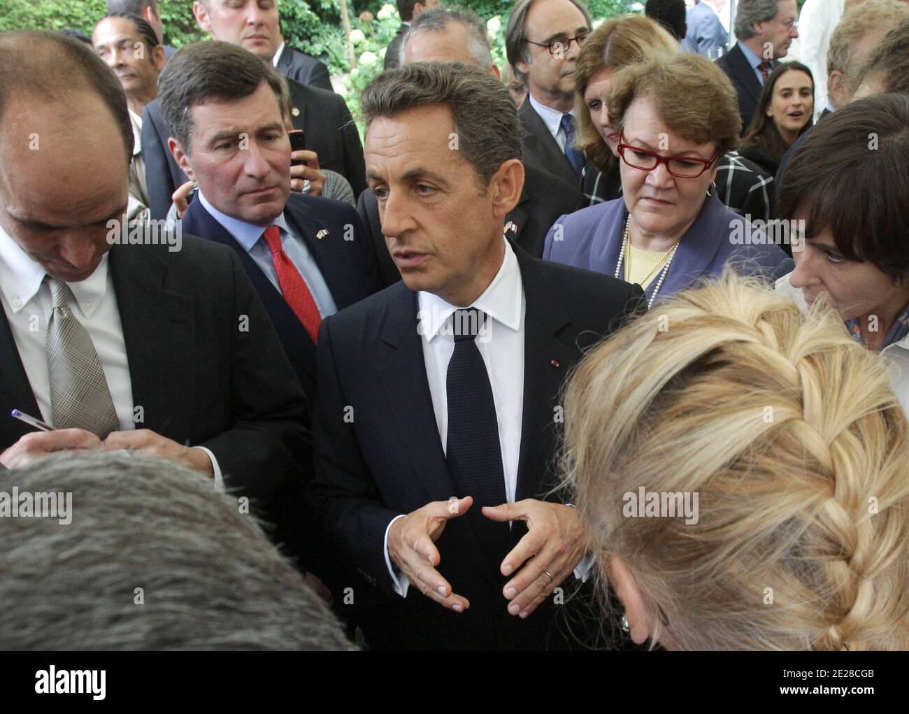 French President Nicolas Sarkozy, gestures as he speaks to the media, after he attends a ceremony at the U.S. Embassy in Paris, France on Septembre 9, 2011, ahead of the 10-year anniversary of the attacks on Sunday. U.S Ambassador Charles Rivkin, left, and embassy staff Margaret C. Flott, right, who survived the attack on the Pentagon September 11. from Sarkozy. Photo by Michel Euler/ABACAPRESS.COM Stock Photo