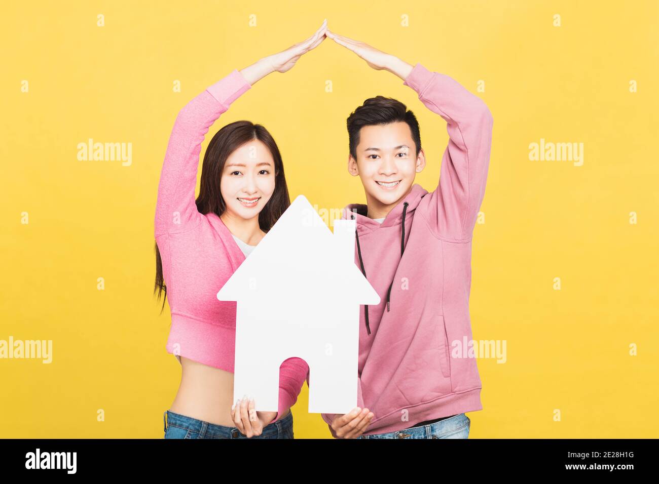 happy young couple holding a small house the in their hands. family and house concept Stock Photo