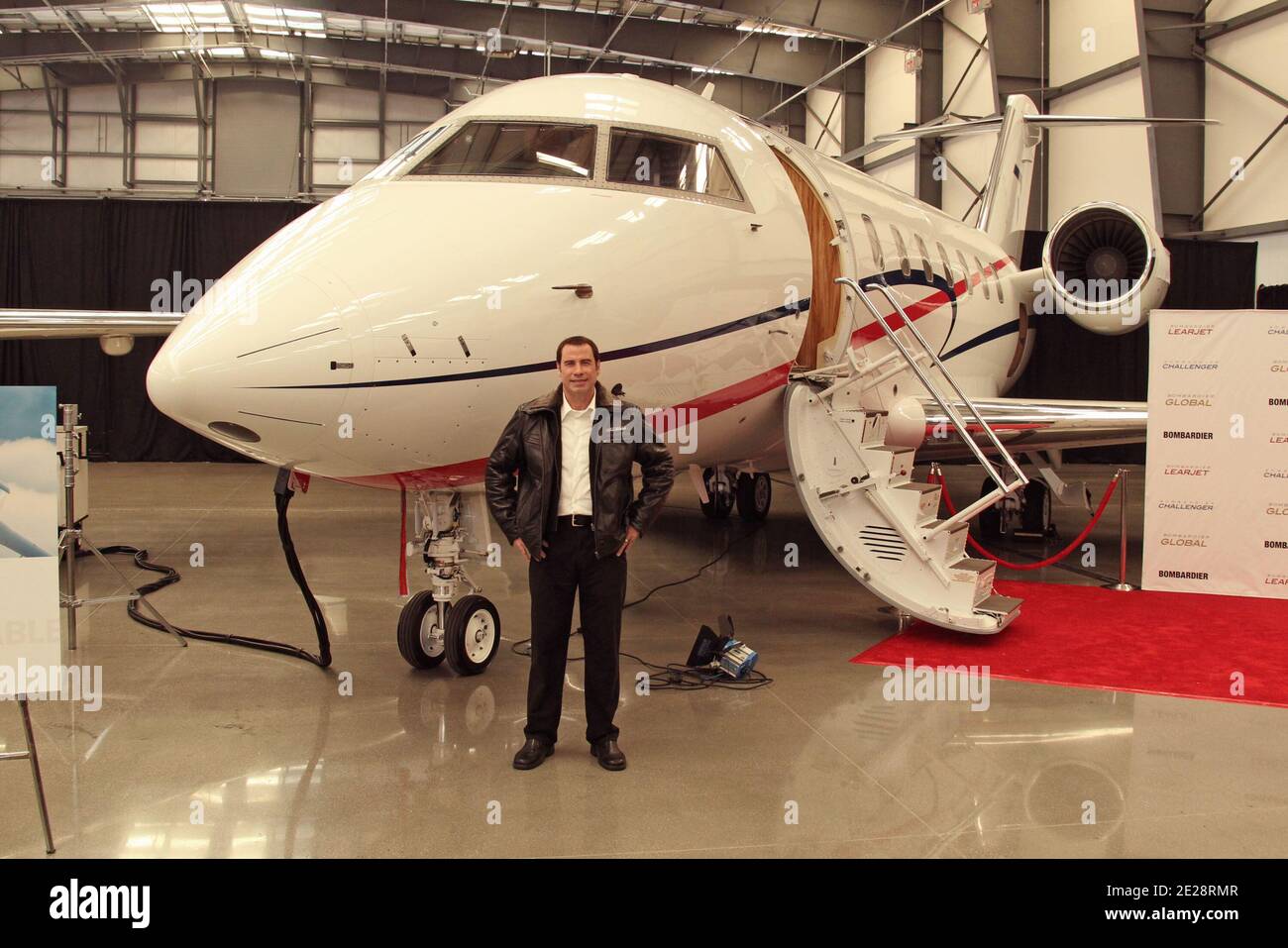 John Travolta, Bombardier Aircraft introduce their latest Aircraft, The Lear Jet, The Challenger, and The Global 5000 Jets in Hangar 25 at the Burbank Airport, in Los Angeles California, USA, September 20, 2011. Photo by Baxter/ABACAPRESS.COM Stock Photo