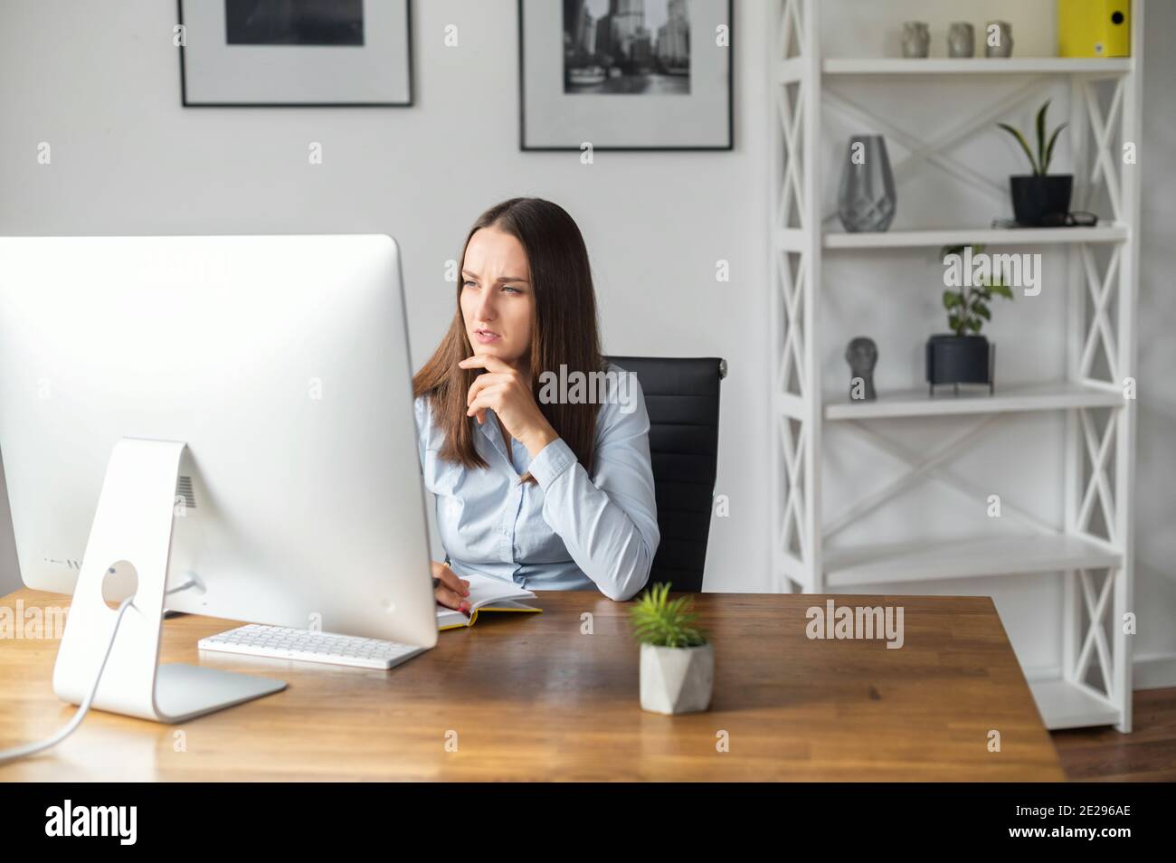 A young woman is using PC in the office Stock Photo - Alamy