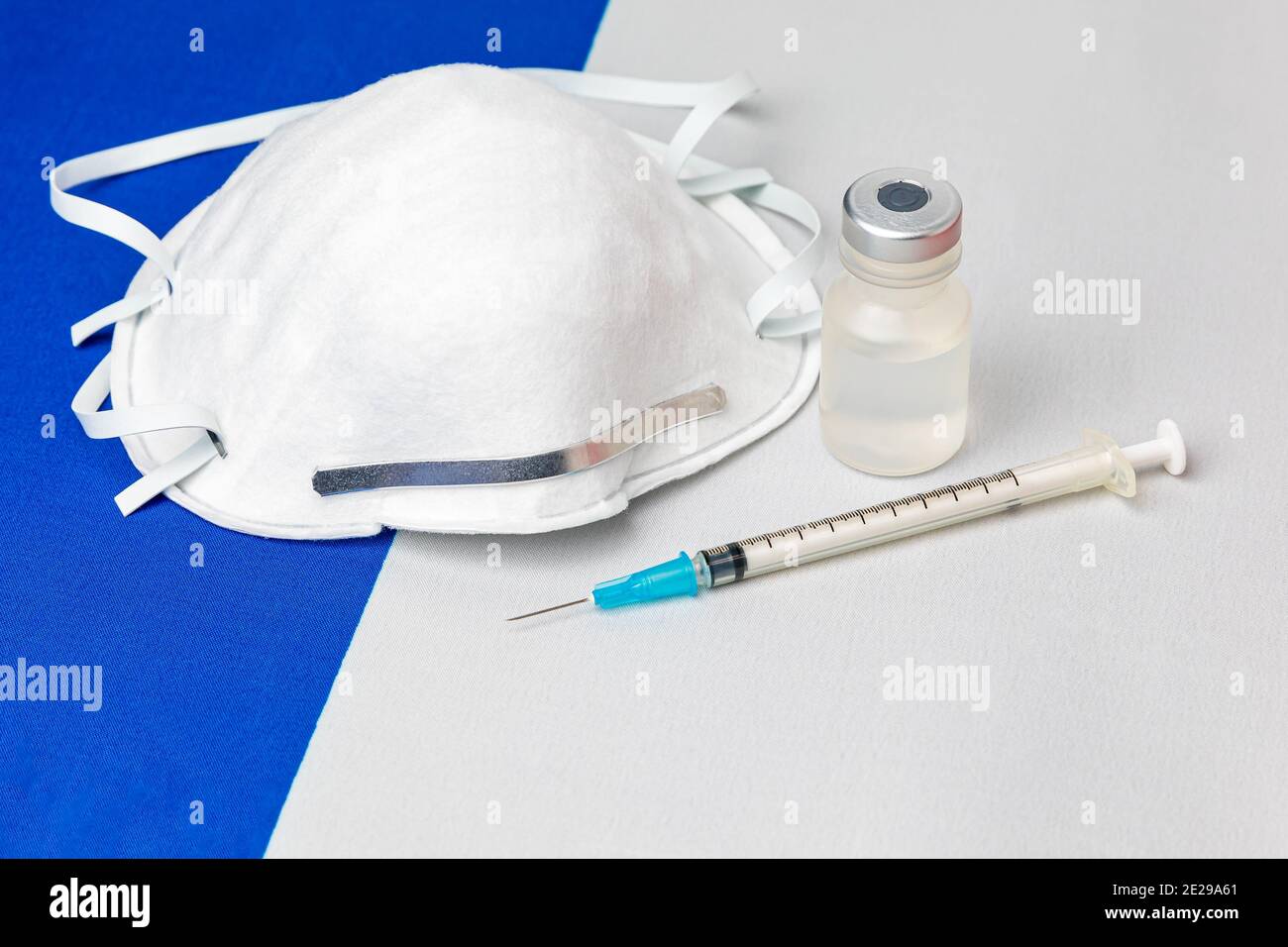 France flag, n95 face mask, needle syringe and vial. Concept of Covid-19 coronavirus vaccine distribution, supply shortage and healthcare crisis Stock Photo