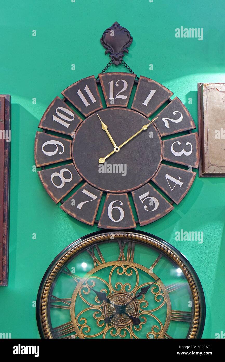 Big vintage round clock at green wall Stock Photo Alamy